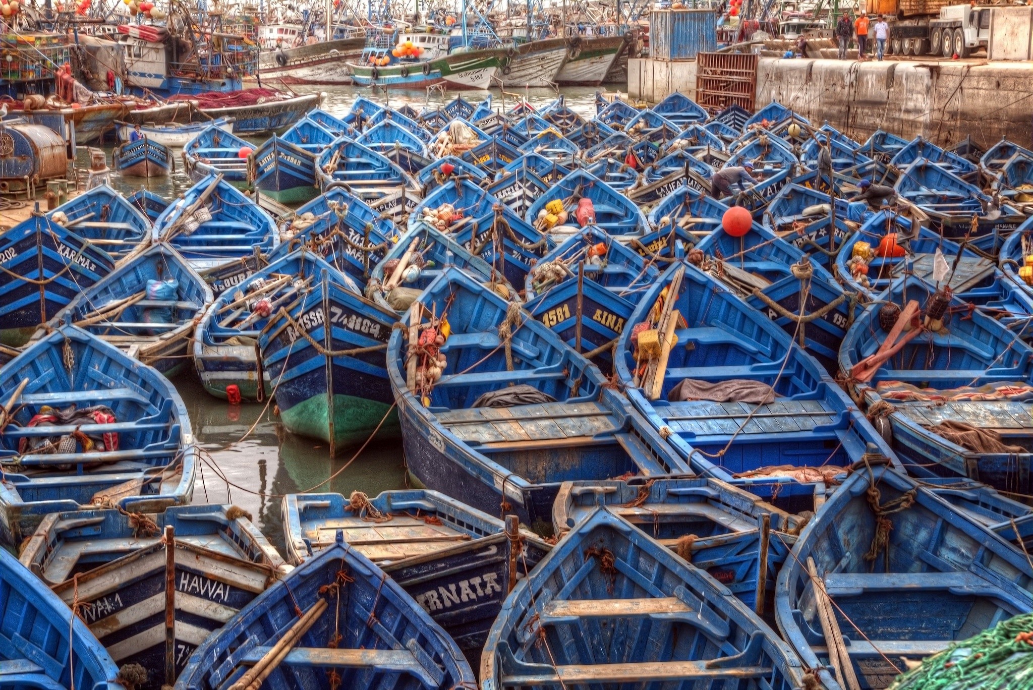 Many blue fishing boats docked in a Moroccan seaport HD Wallpaper