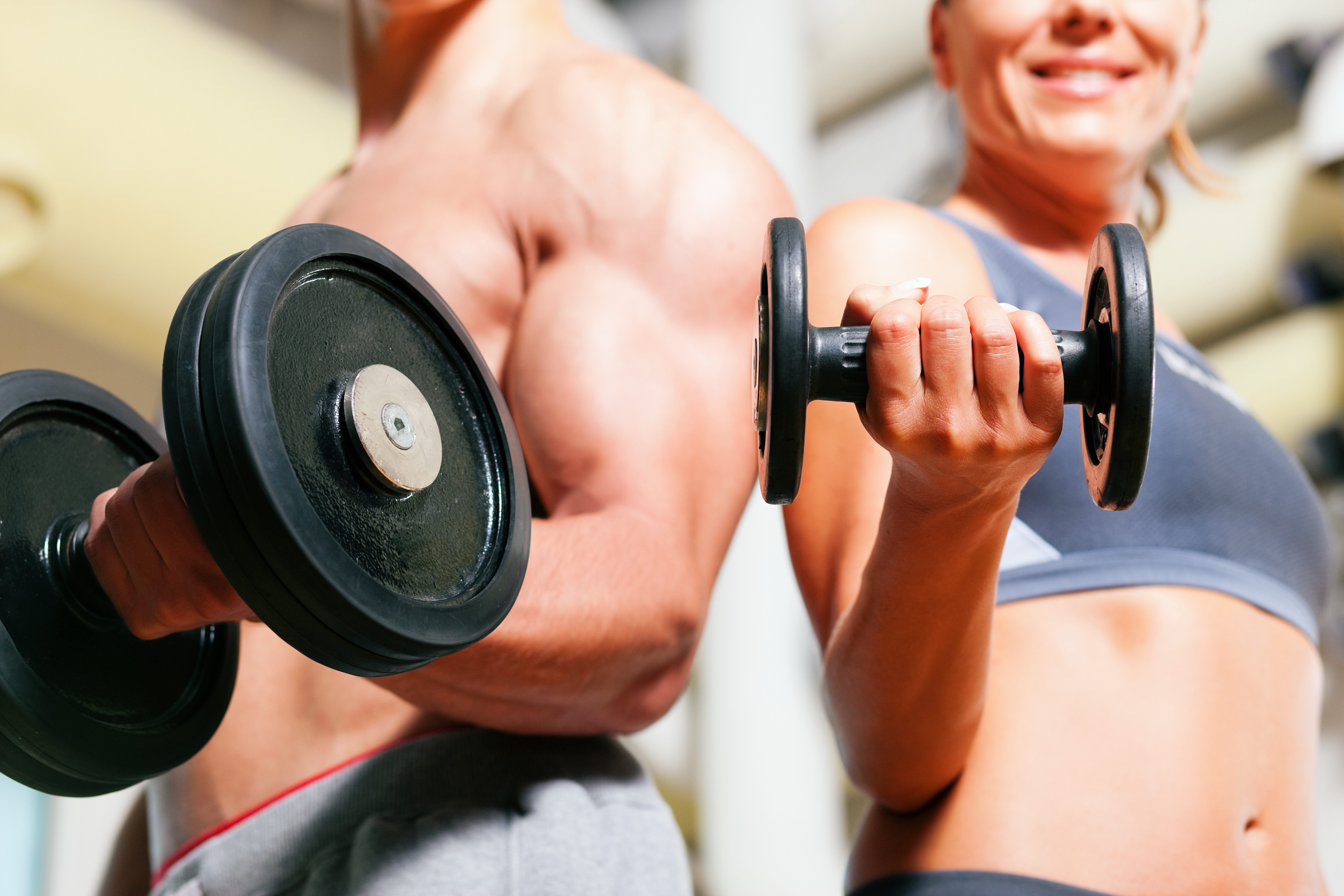 Man and woman lifting dumbbells HD Wallpaper