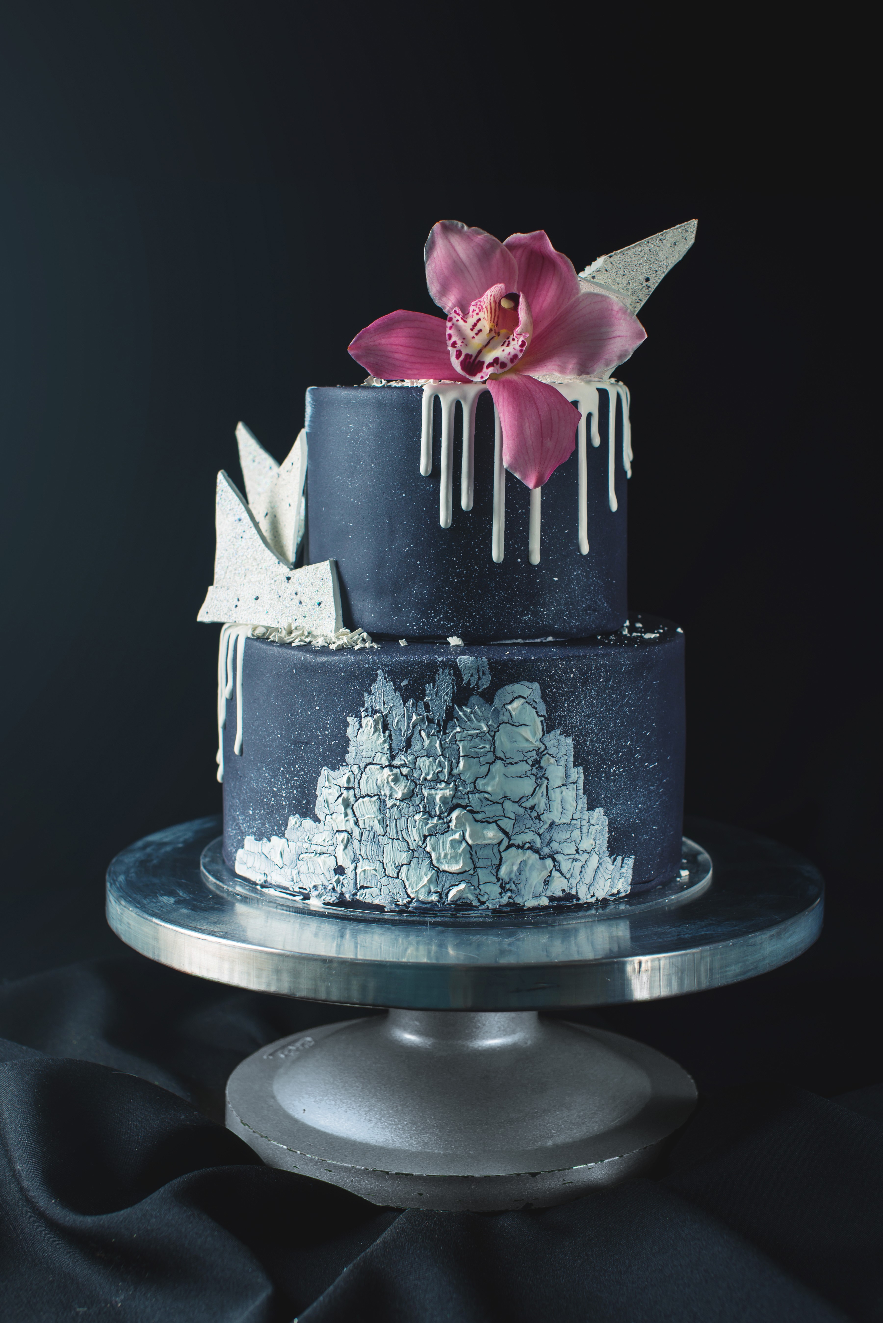 Two-tiered dark blue cake with orchid and white decorations HD Phone Wallpaper