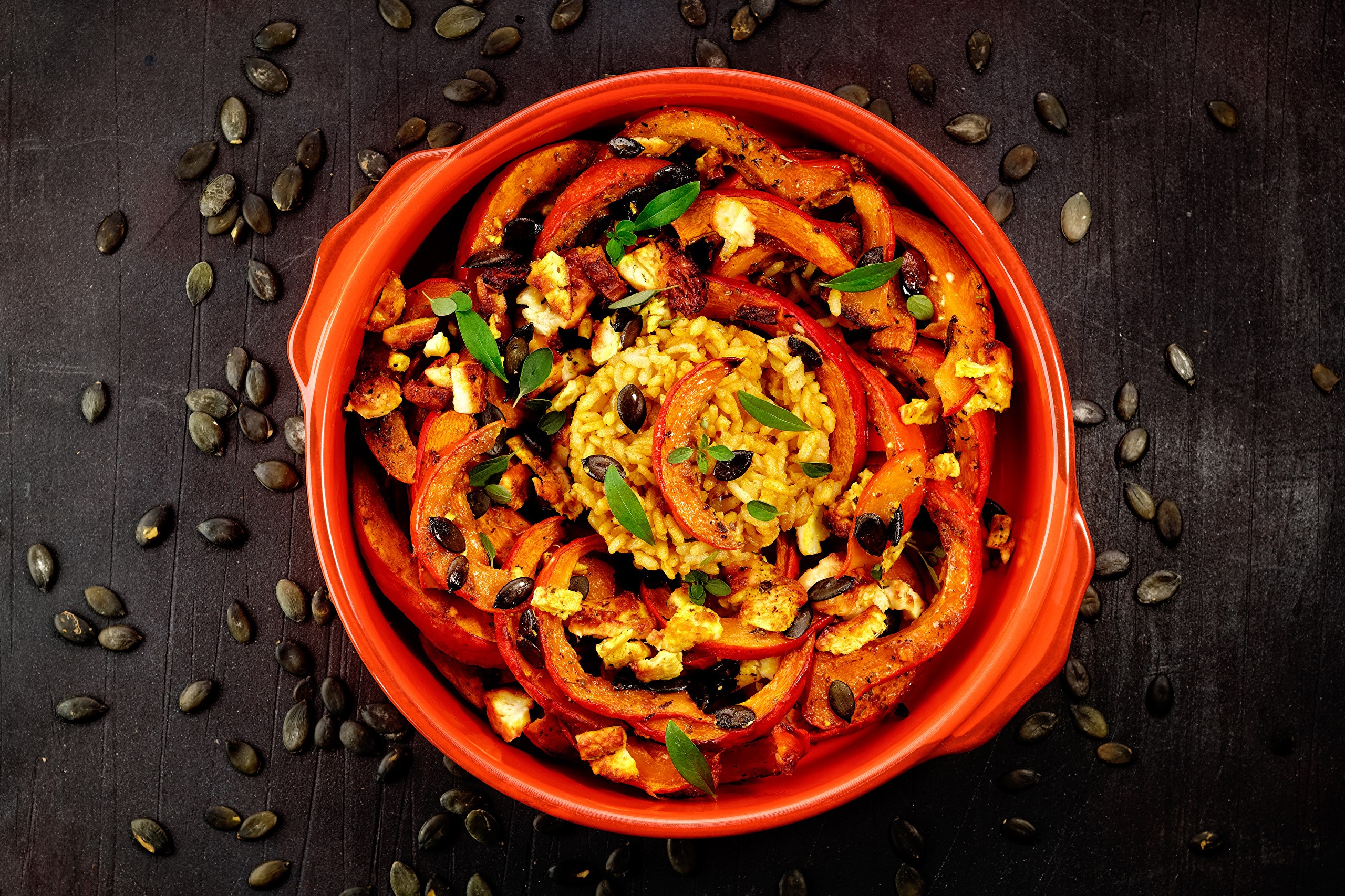Roasted pumpkin slices with rice and herbs in a bowl HD Wallpaper