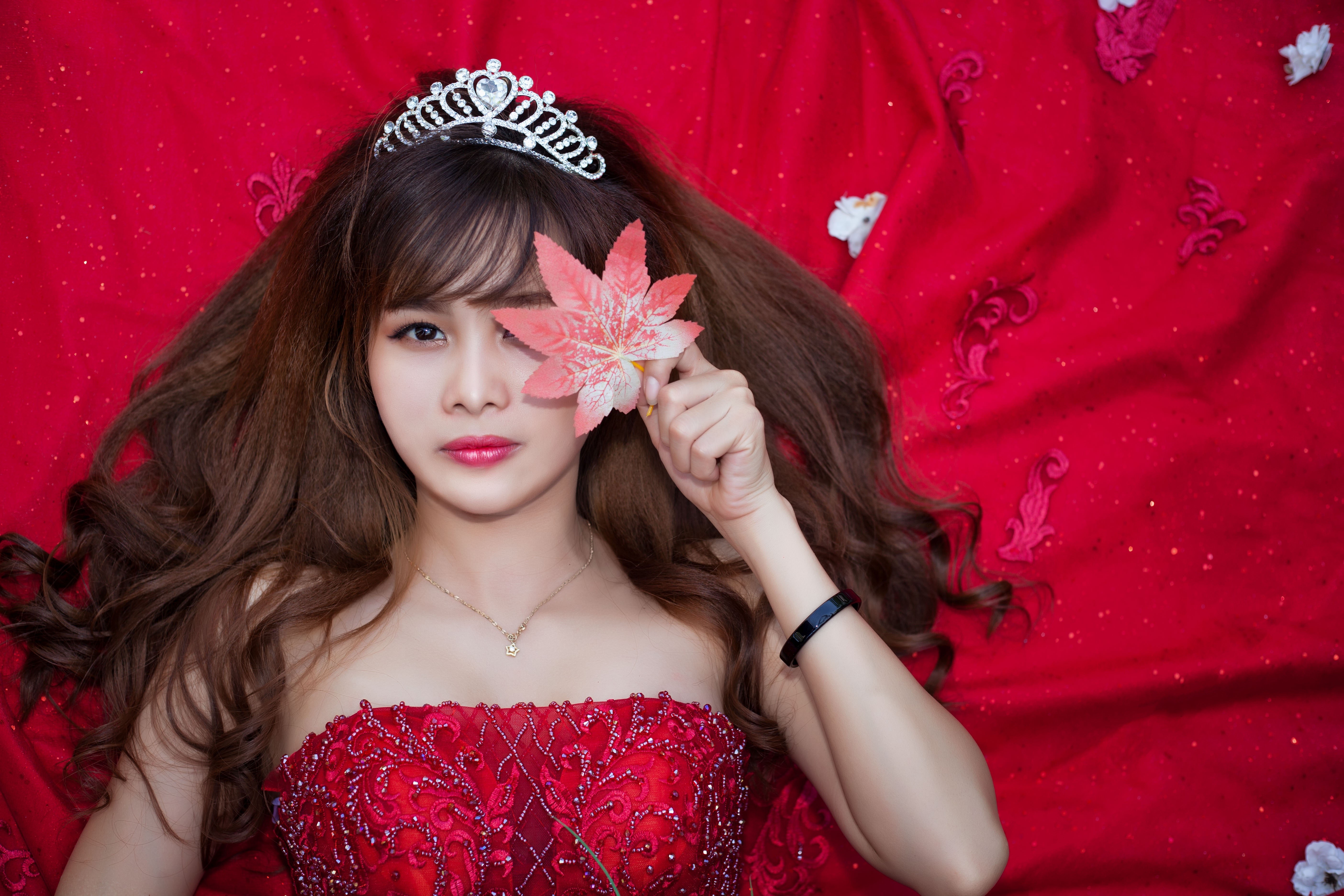 Asian woman with crown and red dress holding leaf HD Wallpaper