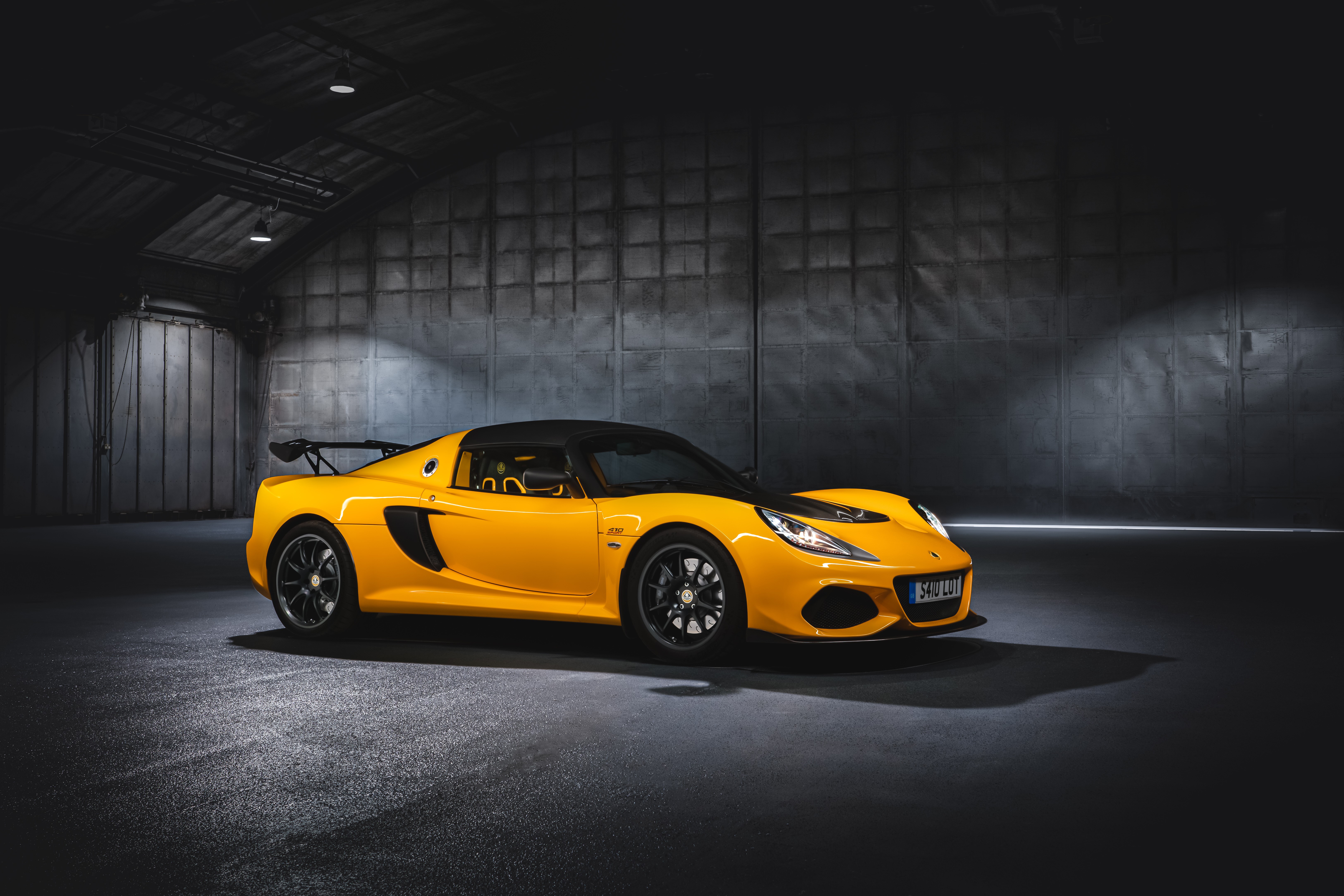 Yellow Lotus Exige Sport 410 in a dark garage HD Wallpaper