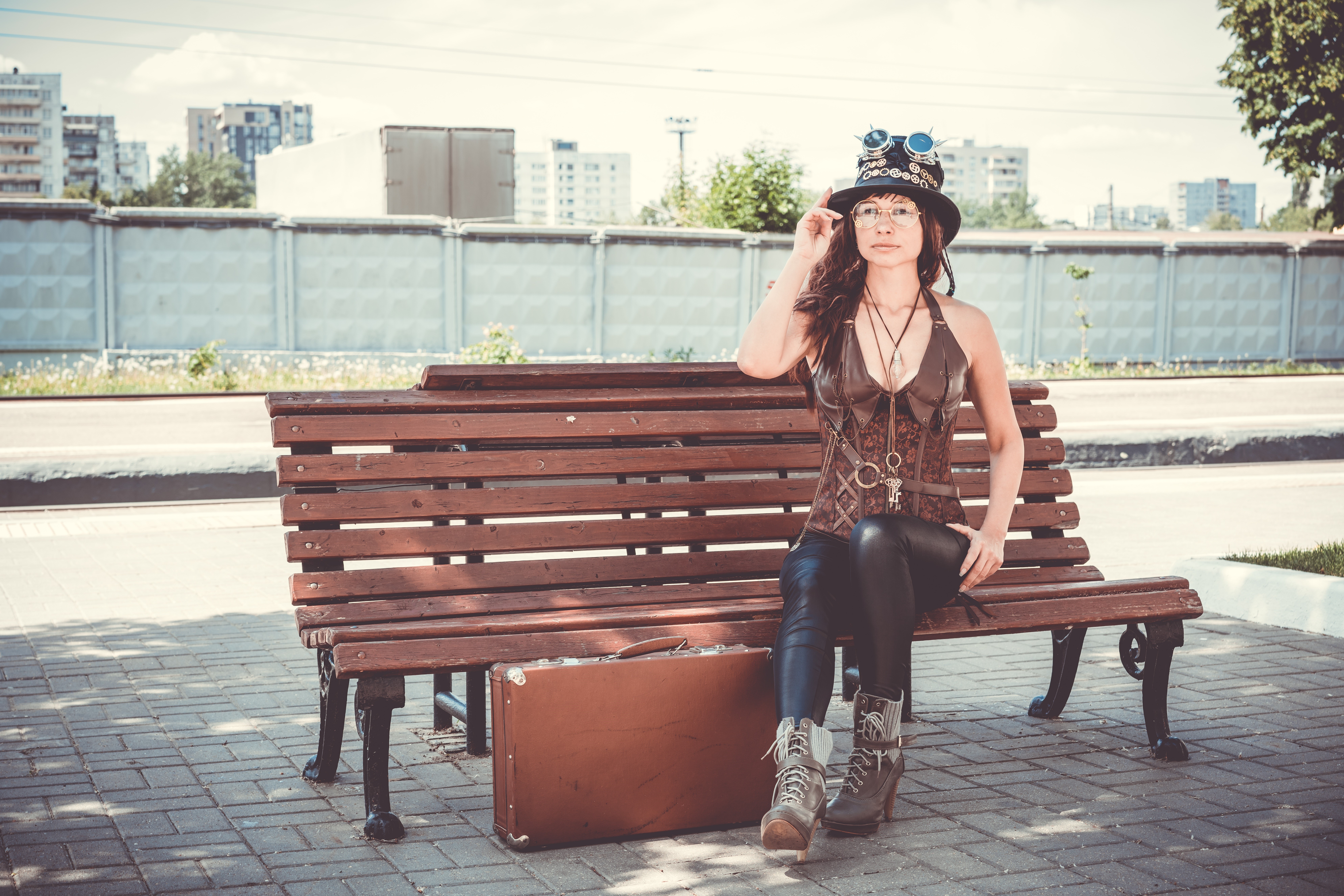Steampunk woman with suitcase sitting on bench HD Wallpaper