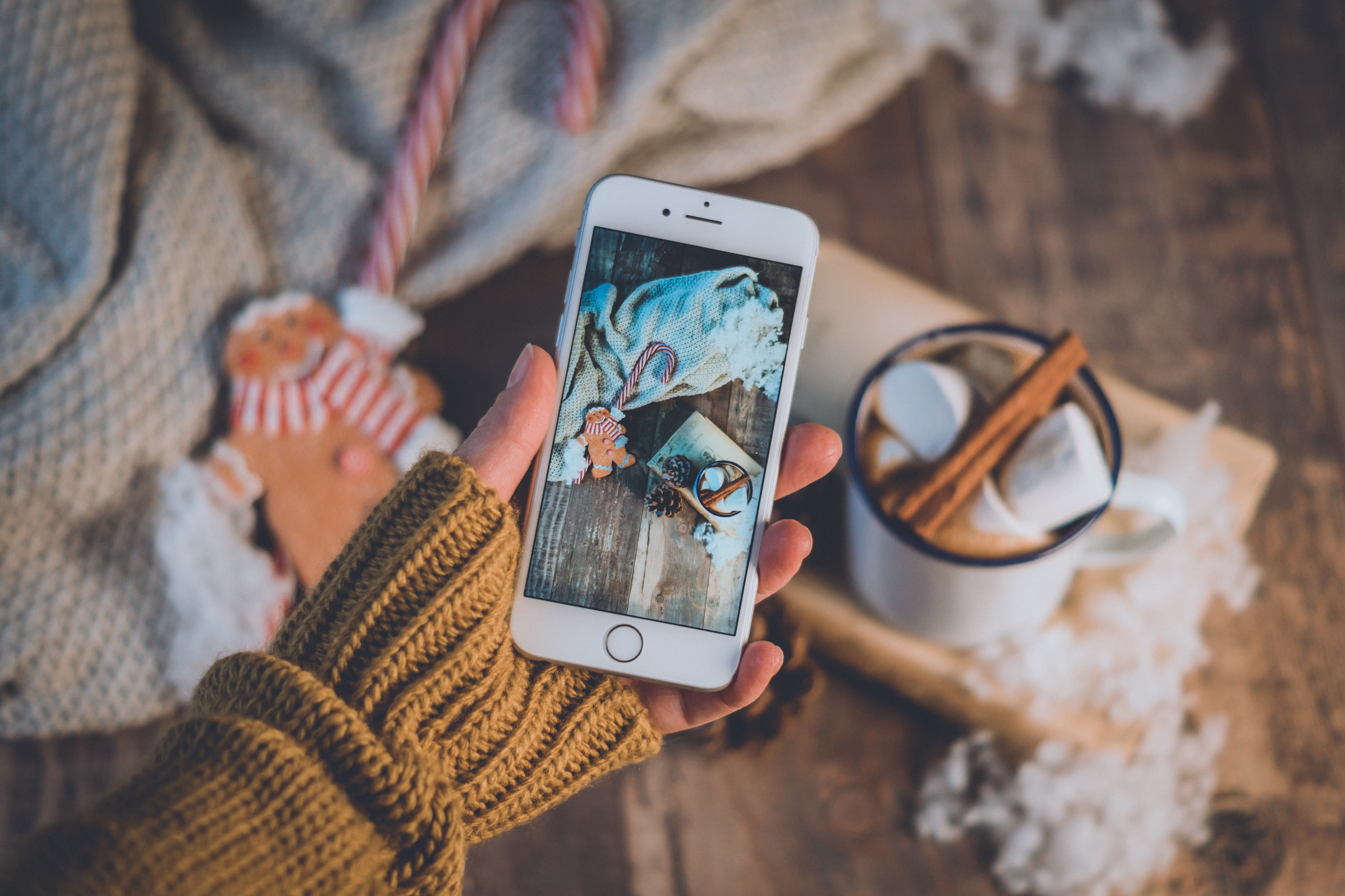 Smartphone showing Christmas scene with hot chocolate HD Wallpaper