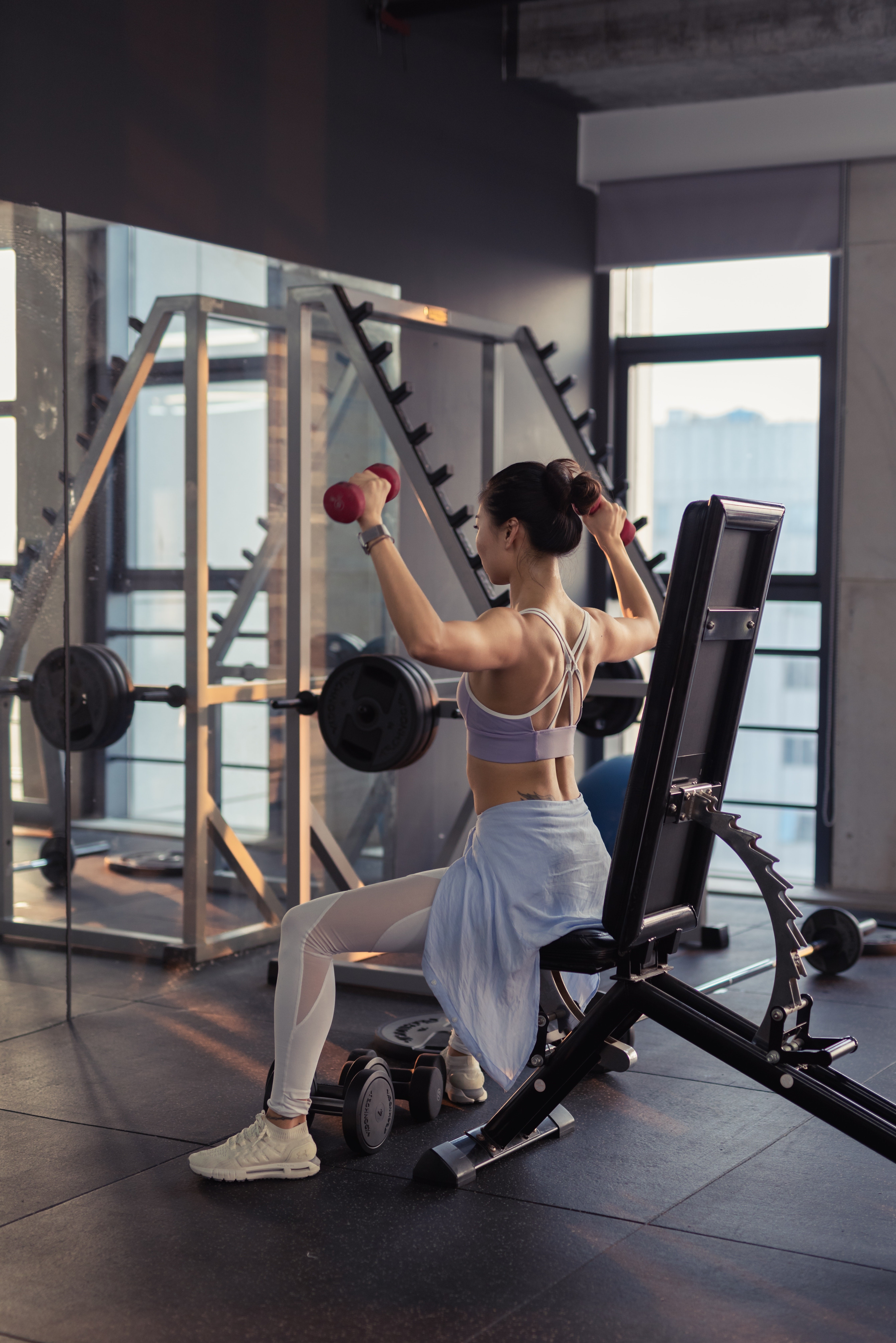 Asian woman doing dumbbell workout in gym HD Phone Wallpaper