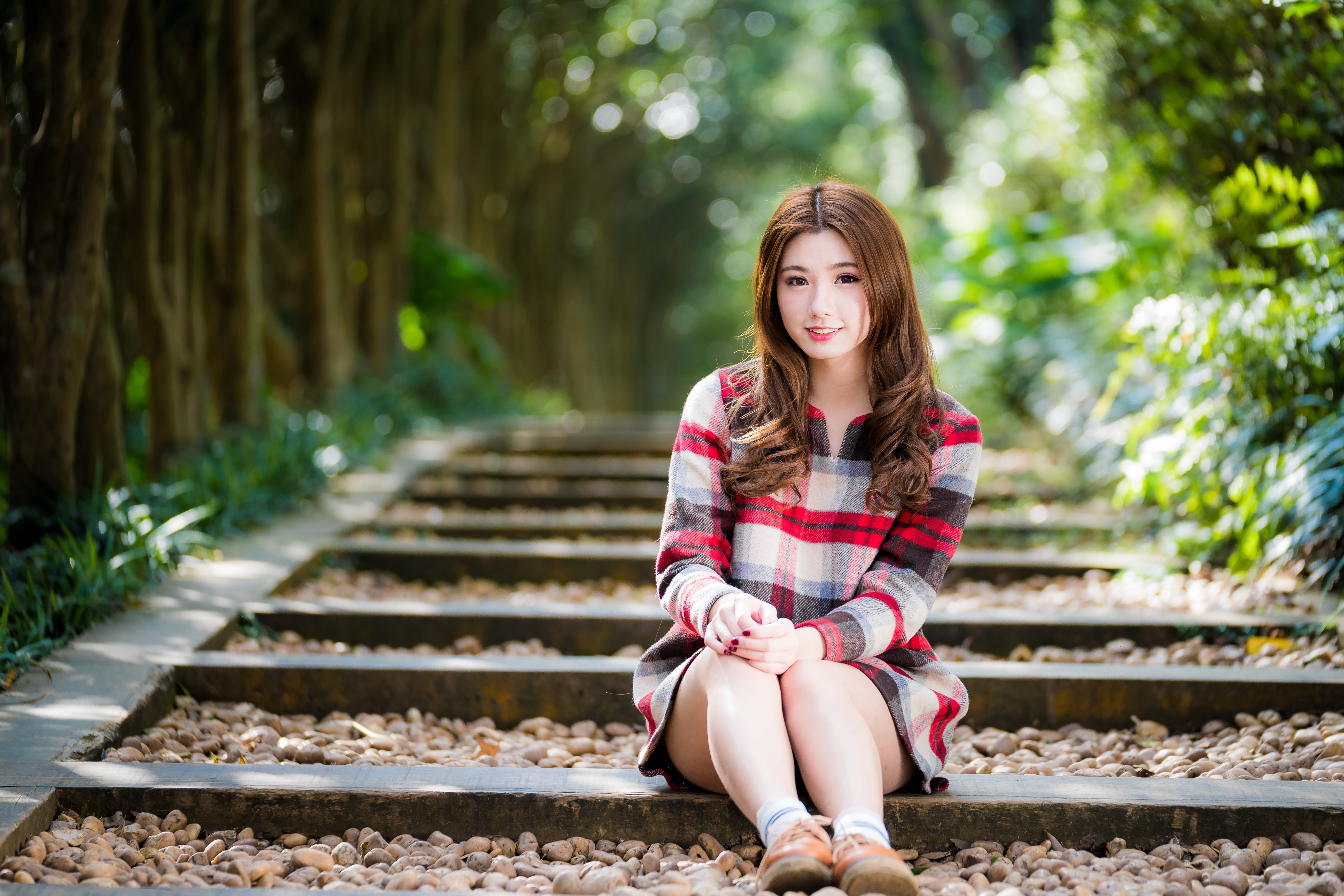 Cute Brown-Haired Girl Sitting on Stone Steps in Bokeh HD Wallpaper