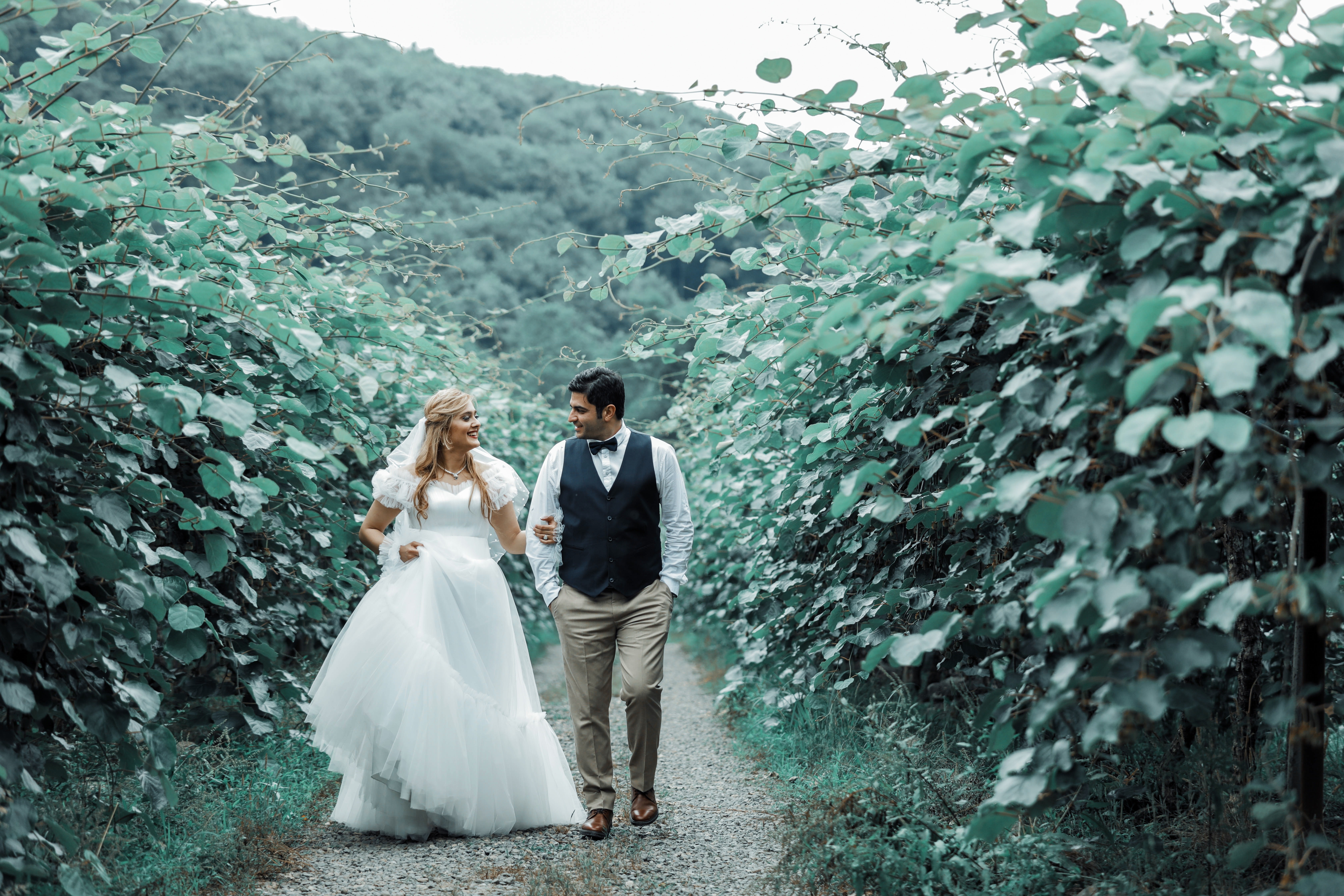 Bride and Groom walking on a trail HD Wallpaper