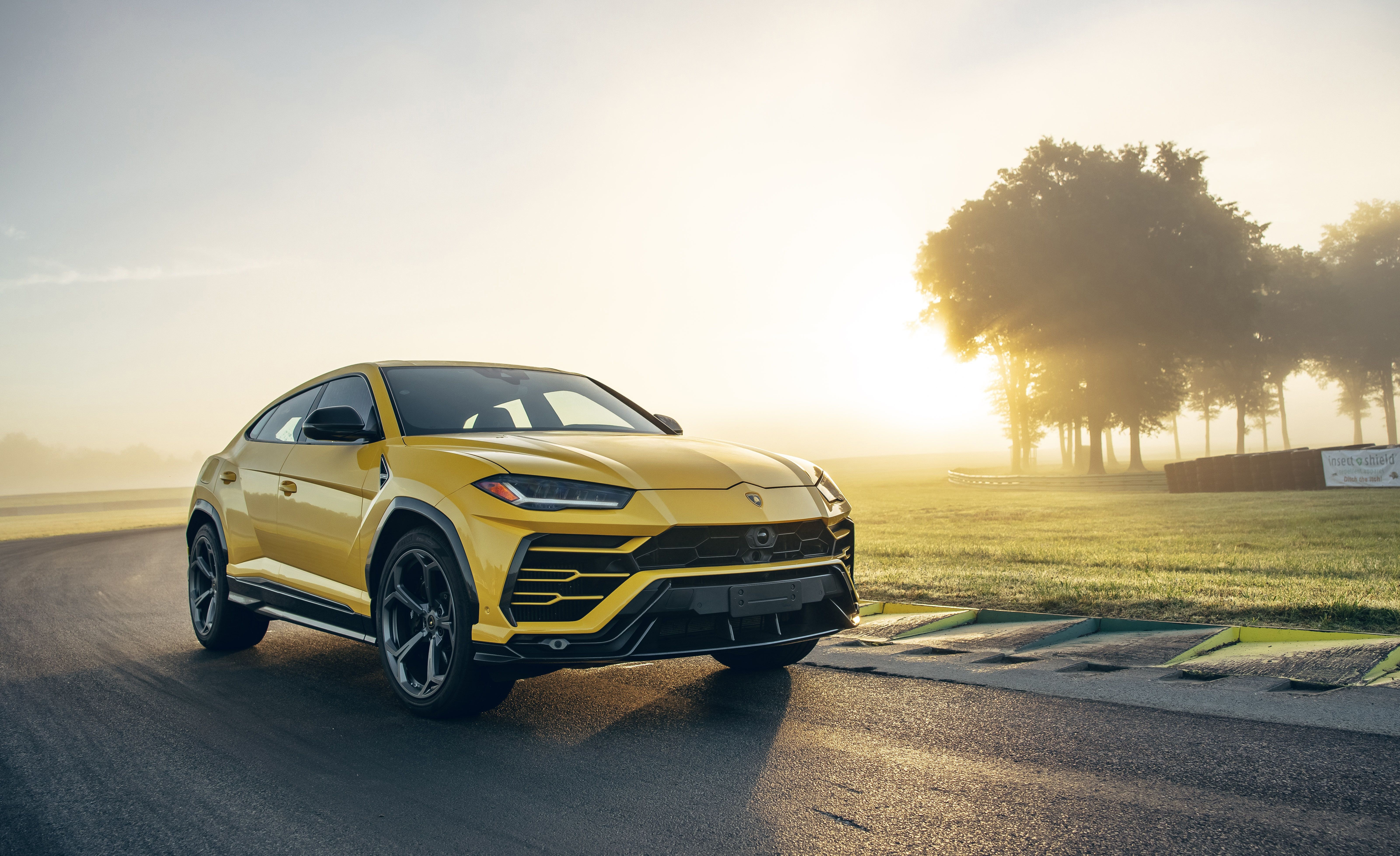 Yellow Lamborghini Urus on a Race Track HD Wallpaper