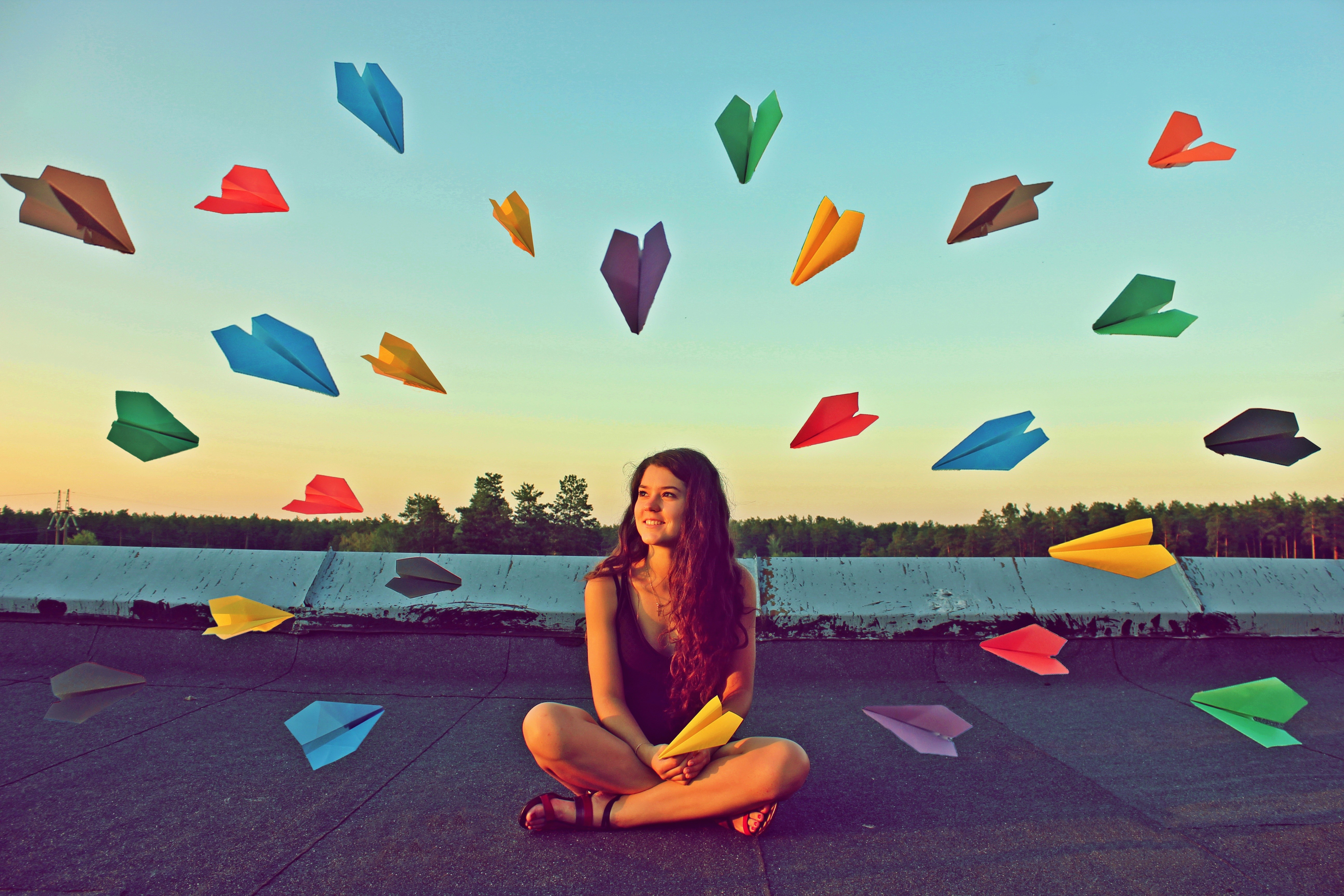 Girl sitting with paper airplanes HD Wallpaper