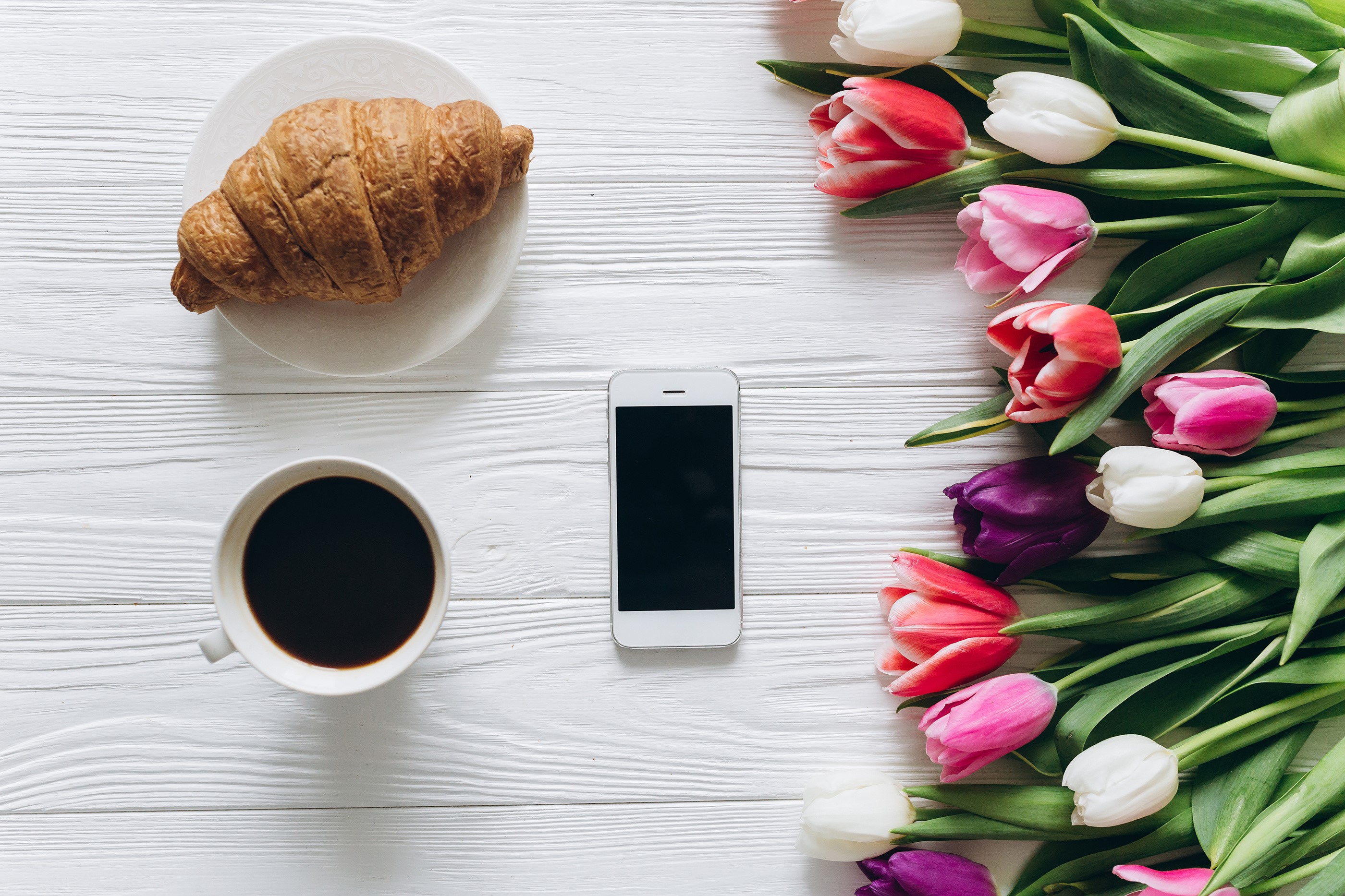 Croissant, Coffee, Tulips, and Smartphone on White Table HD Wallpaper