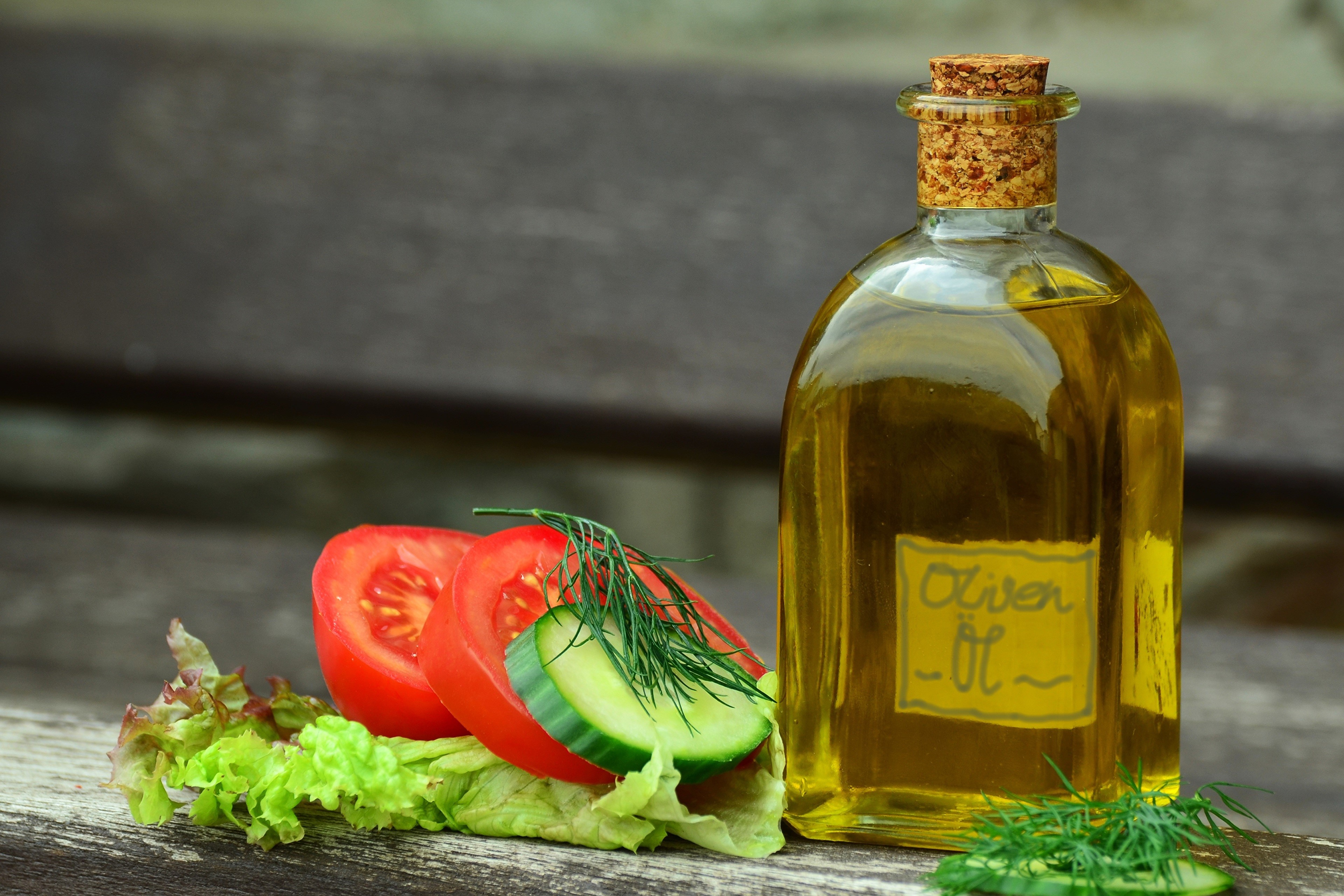 Olive oil bottle with tomatoes, cucumbers, and lettuce HD Wallpaper
