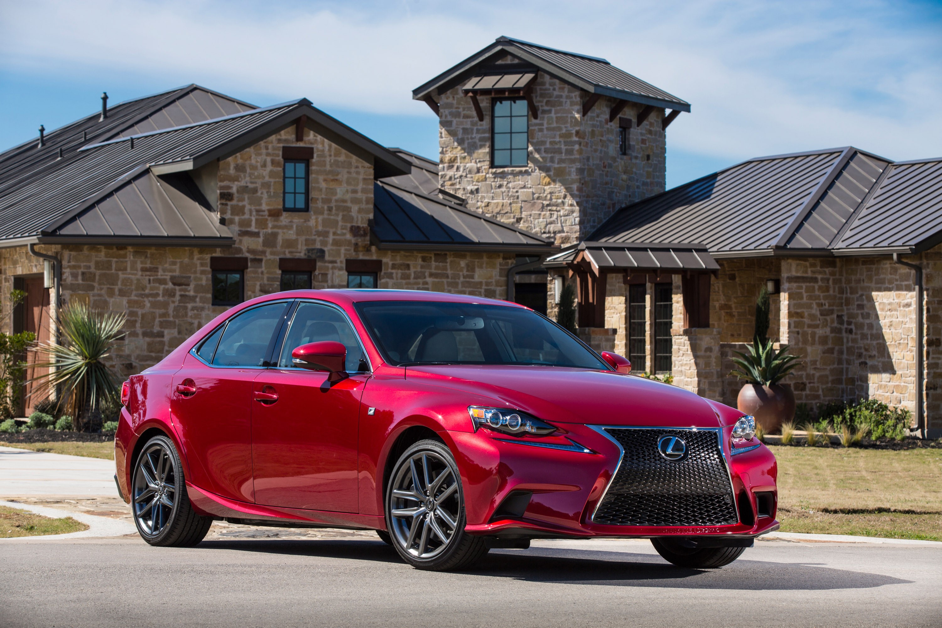 Red Lexus IS F Sedan parked in front of a stone house HD Wallpaper