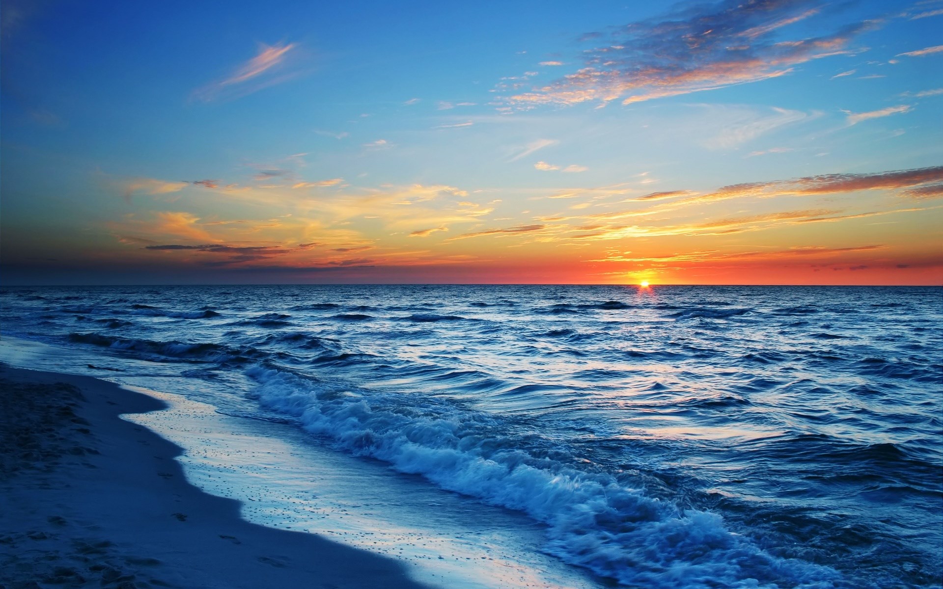 Sunset over the ocean with waves and beach HD Wallpaper