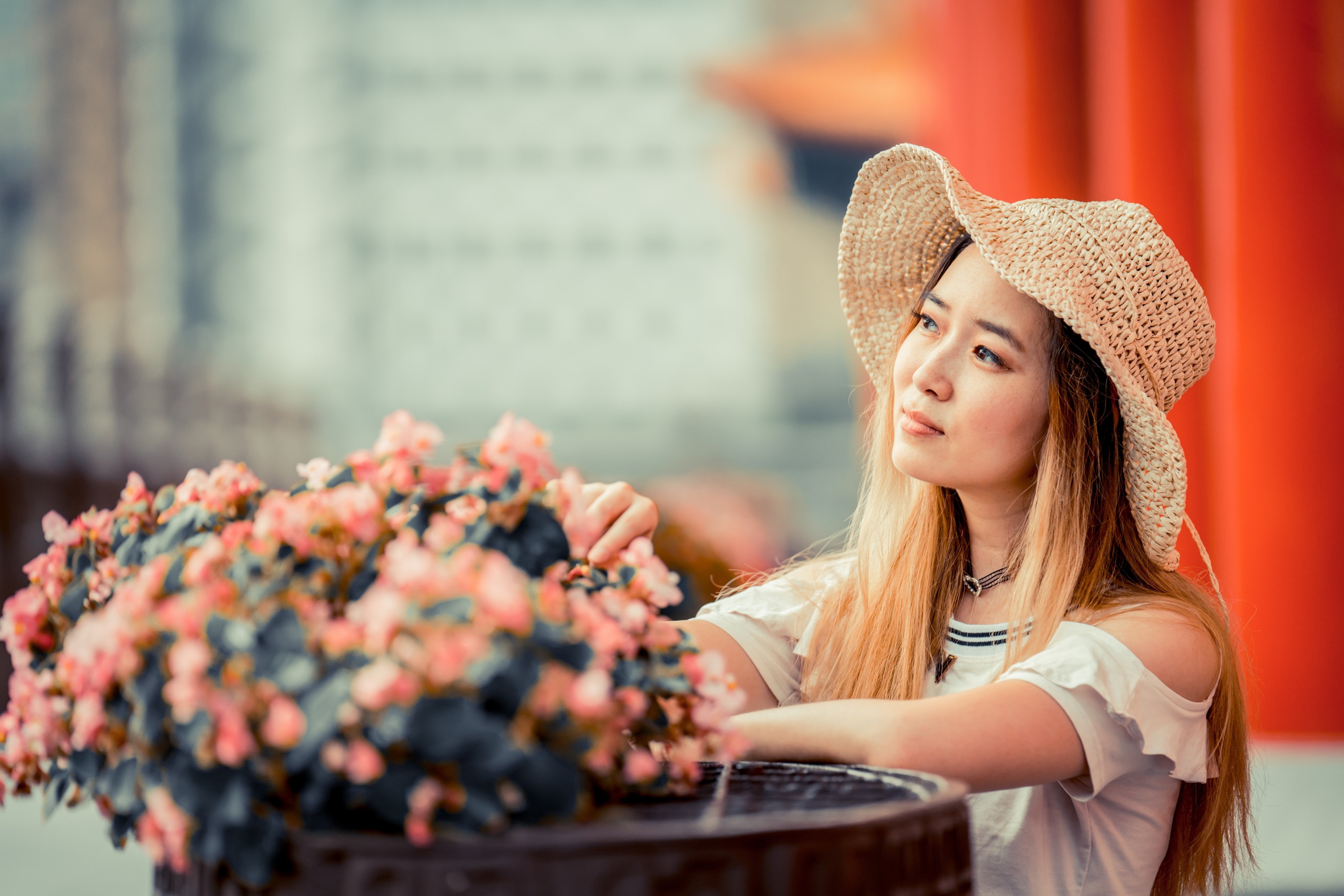 Asian woman wearing a straw hat near flowers HD Wallpaper