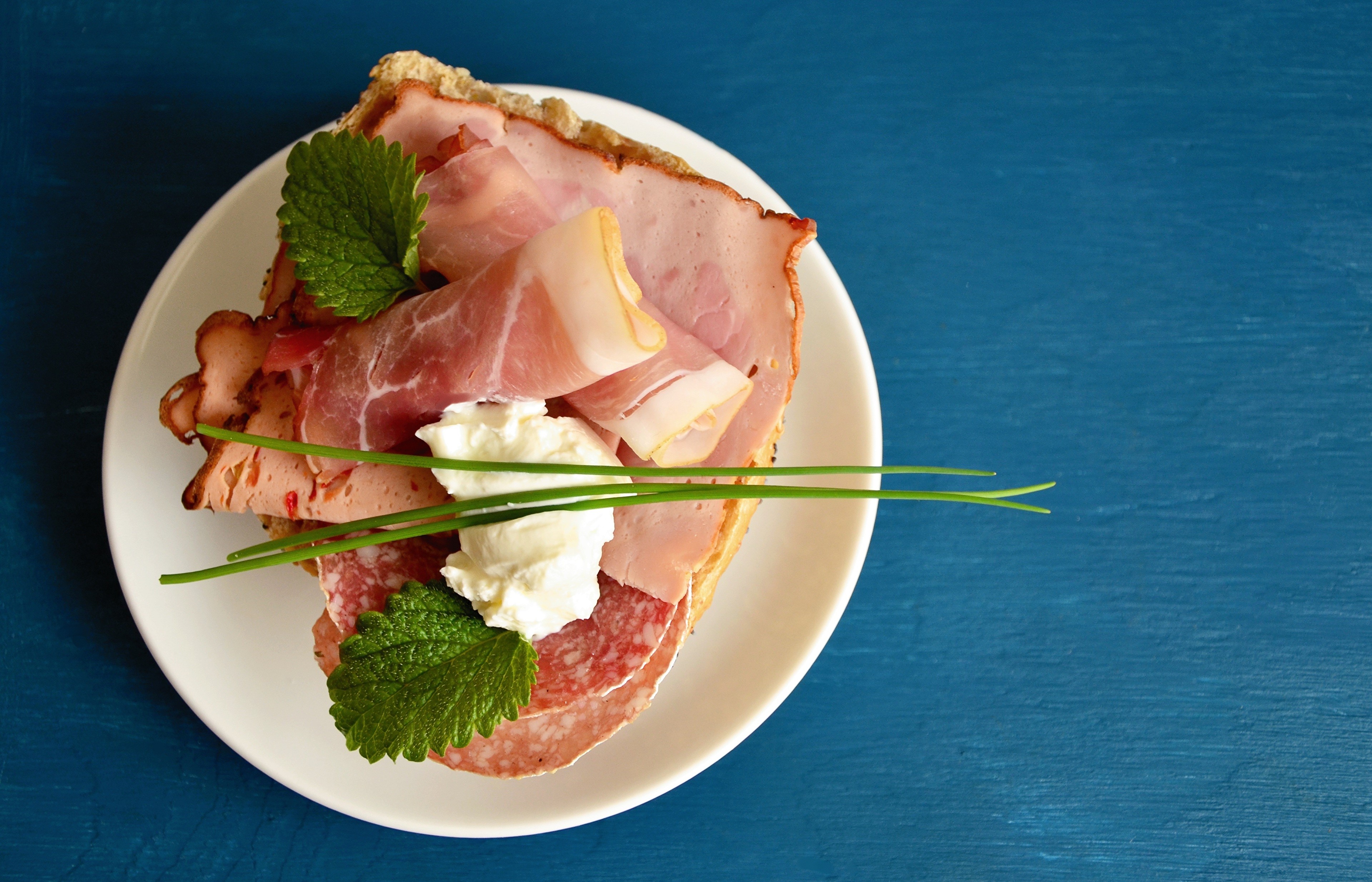 Open-faced sandwich with ham, sausage, and cheese on a plate HD Wallpaper