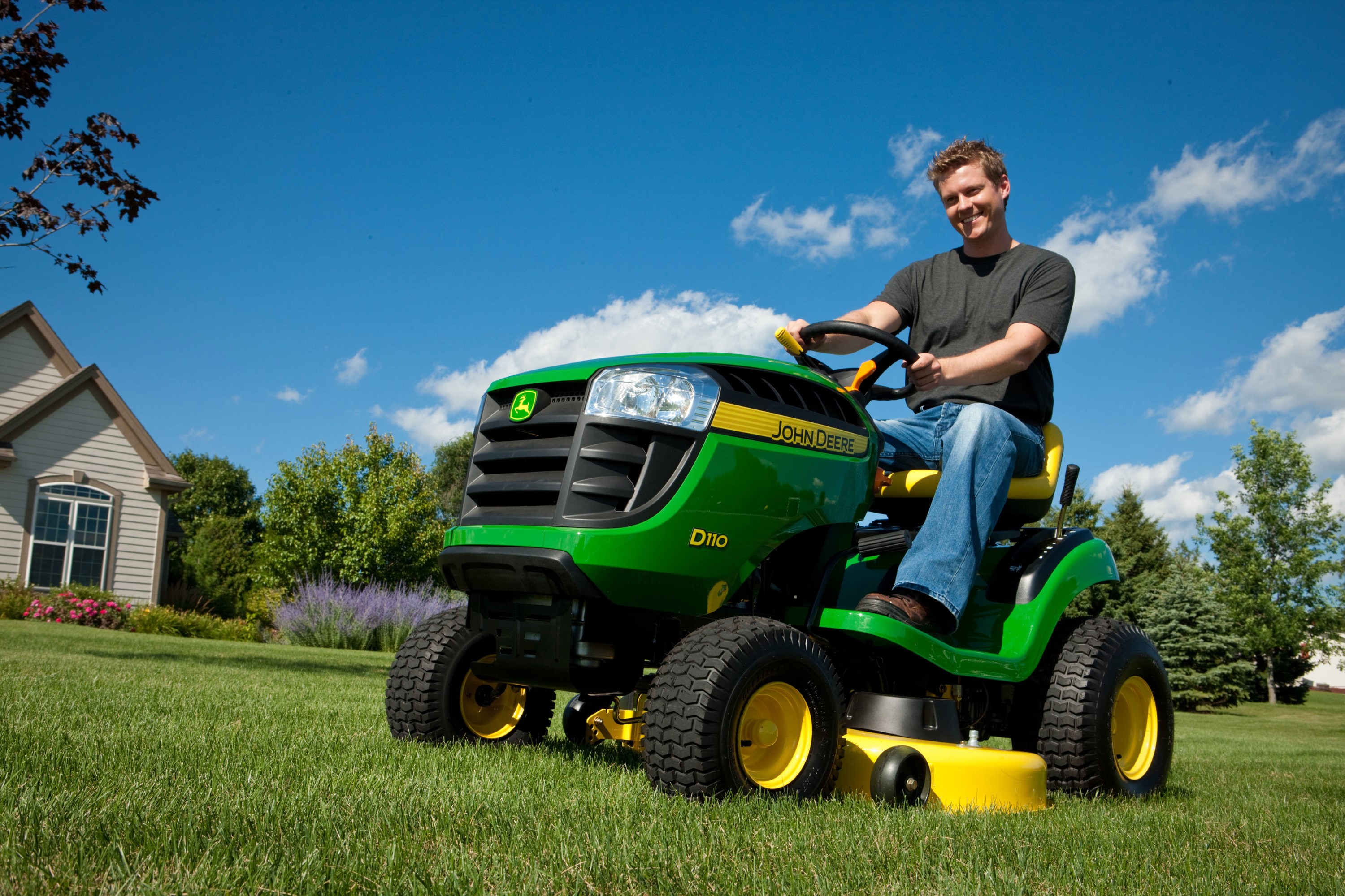 Man on John Deere D110 riding lawn mower HD Wallpaper