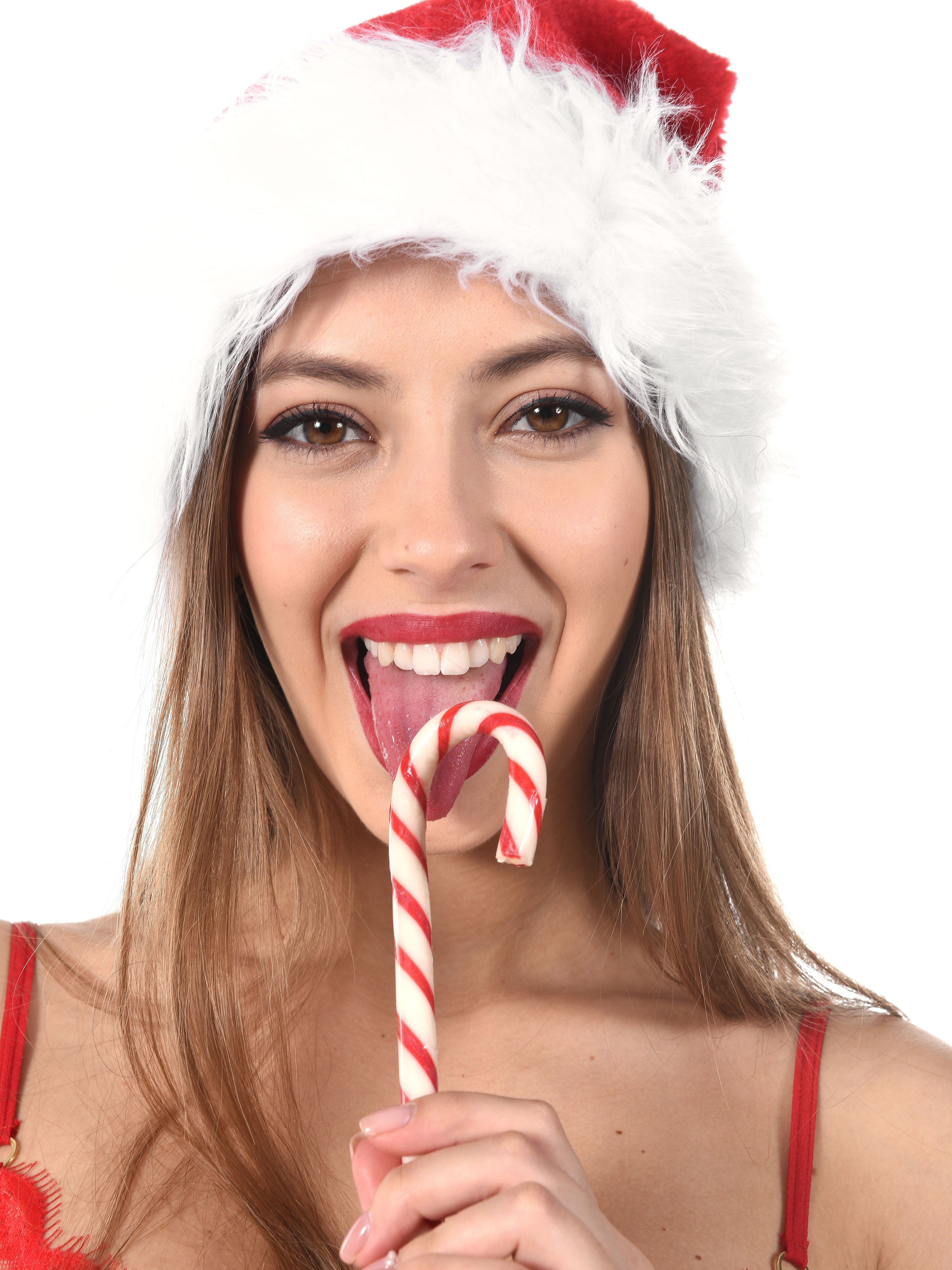 Woman in Santa hat with candy cane HD Phone Wallpaper