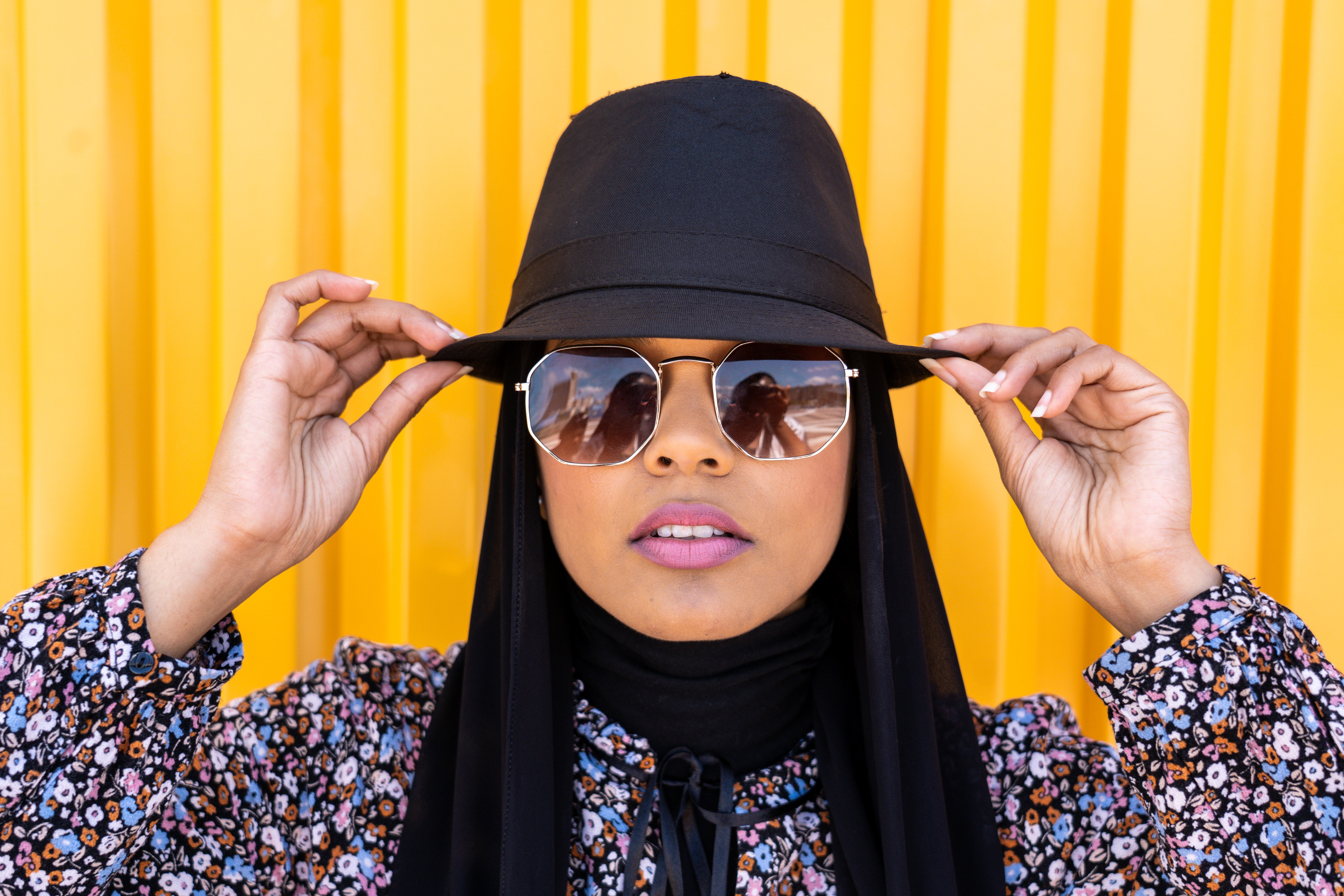 Woman in Hat and Glasses with Floral Shirt HD Wallpaper
