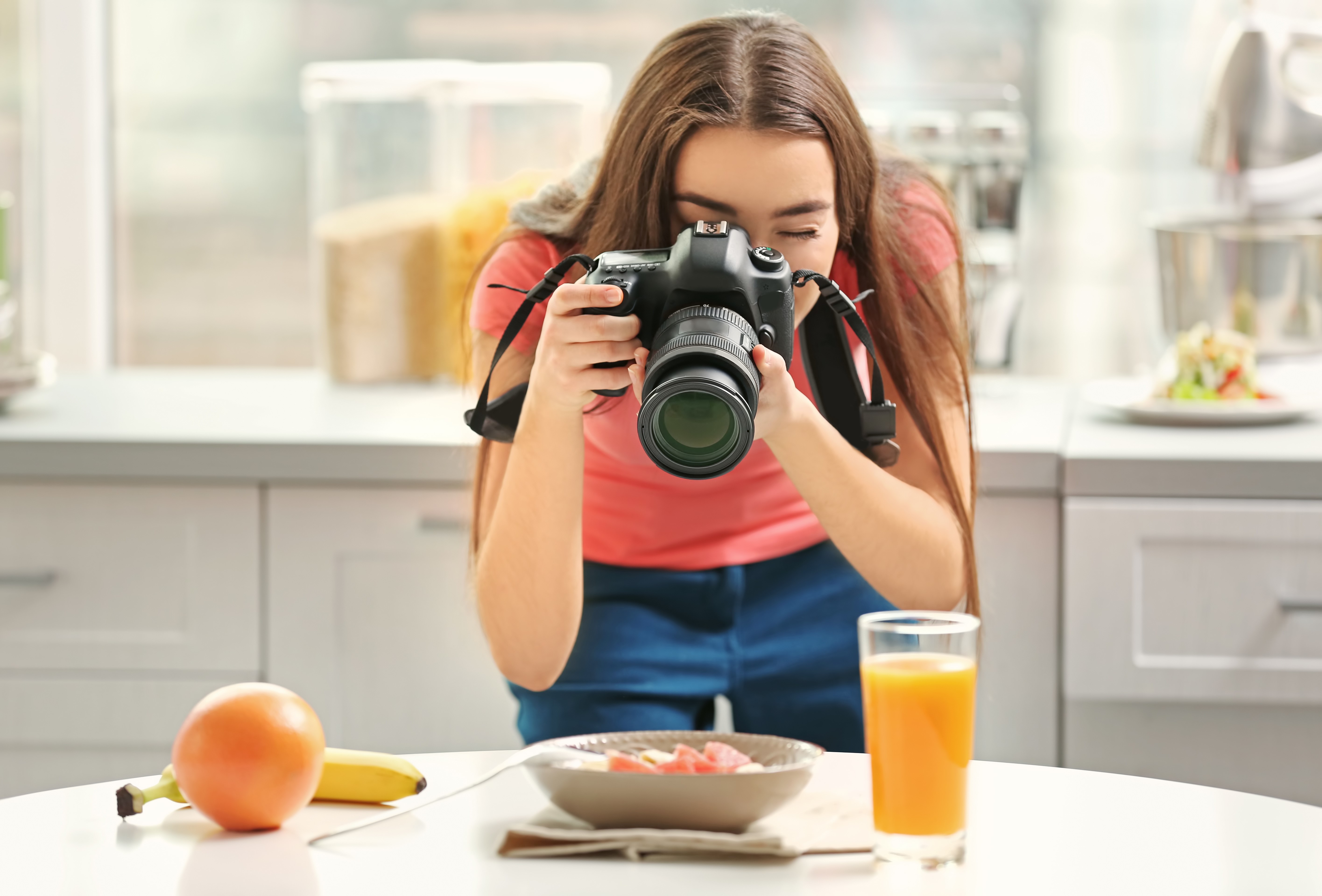 Young woman photographing food with a DSLR camera HD Wallpaper