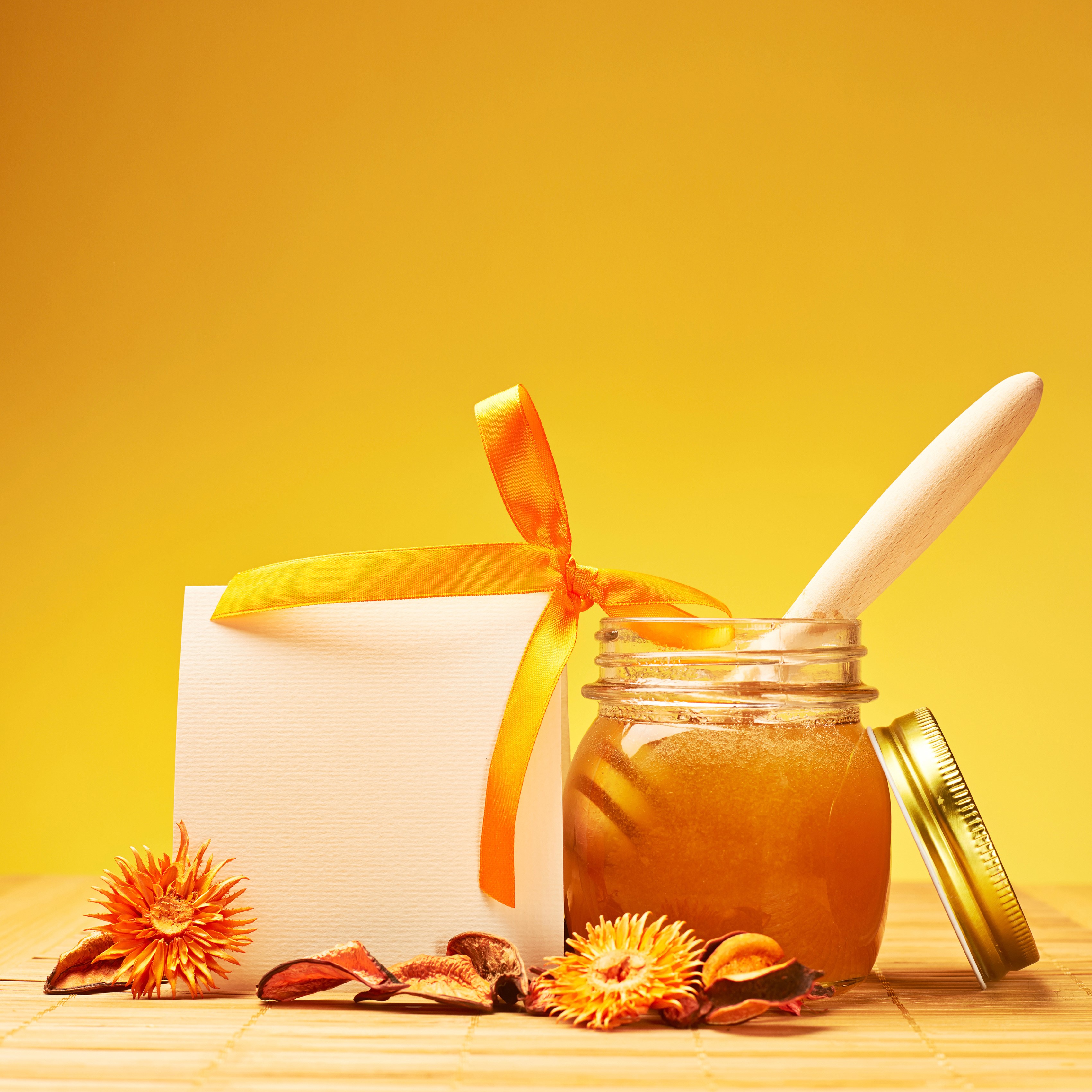 Honey jar with ribbon and dried flowers HD Wallpaper