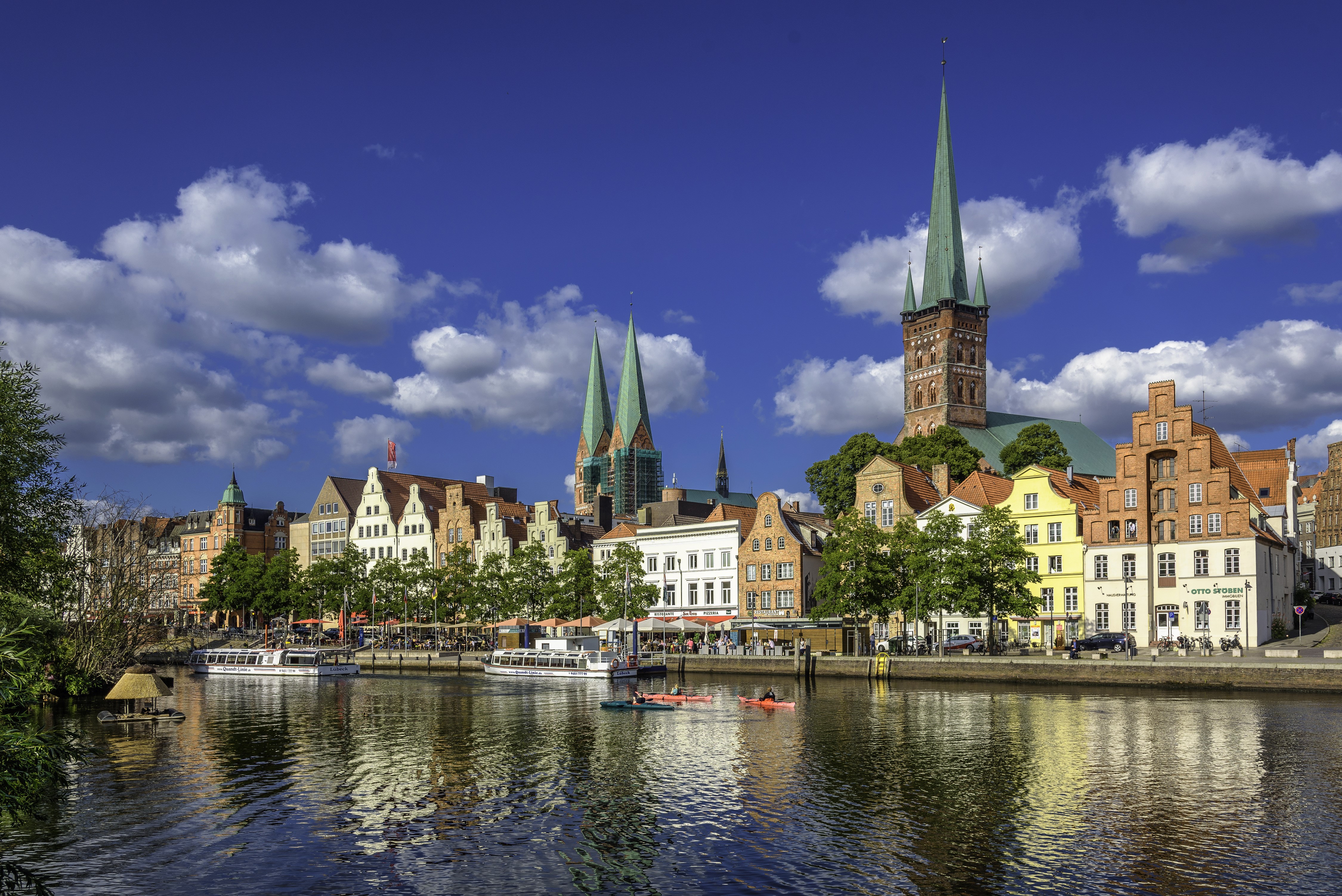 Luebeck, Germany skyline with river and boats HD Wallpaper