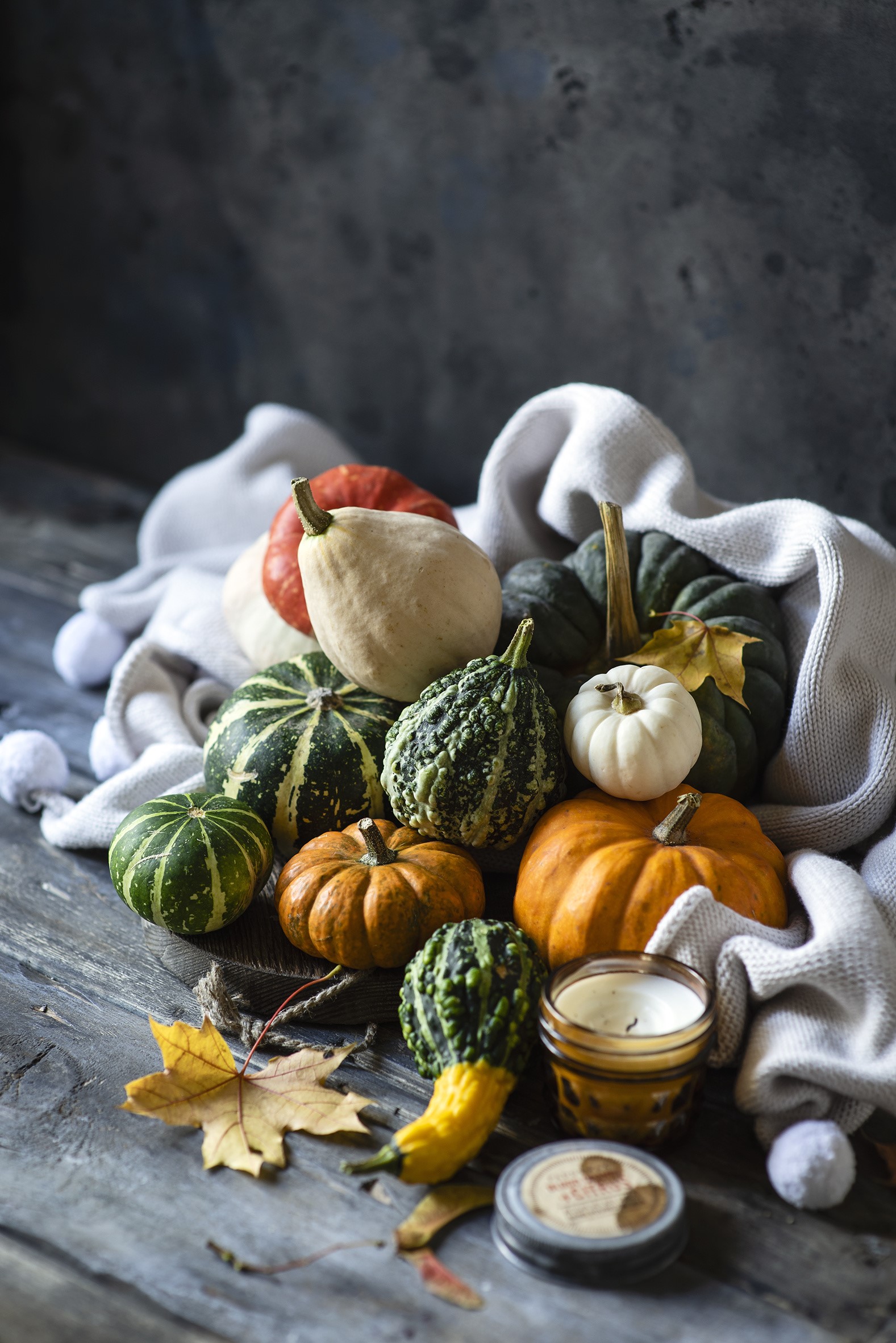Autumn pumpkins and gourds with candle on wood HD Phone Wallpaper