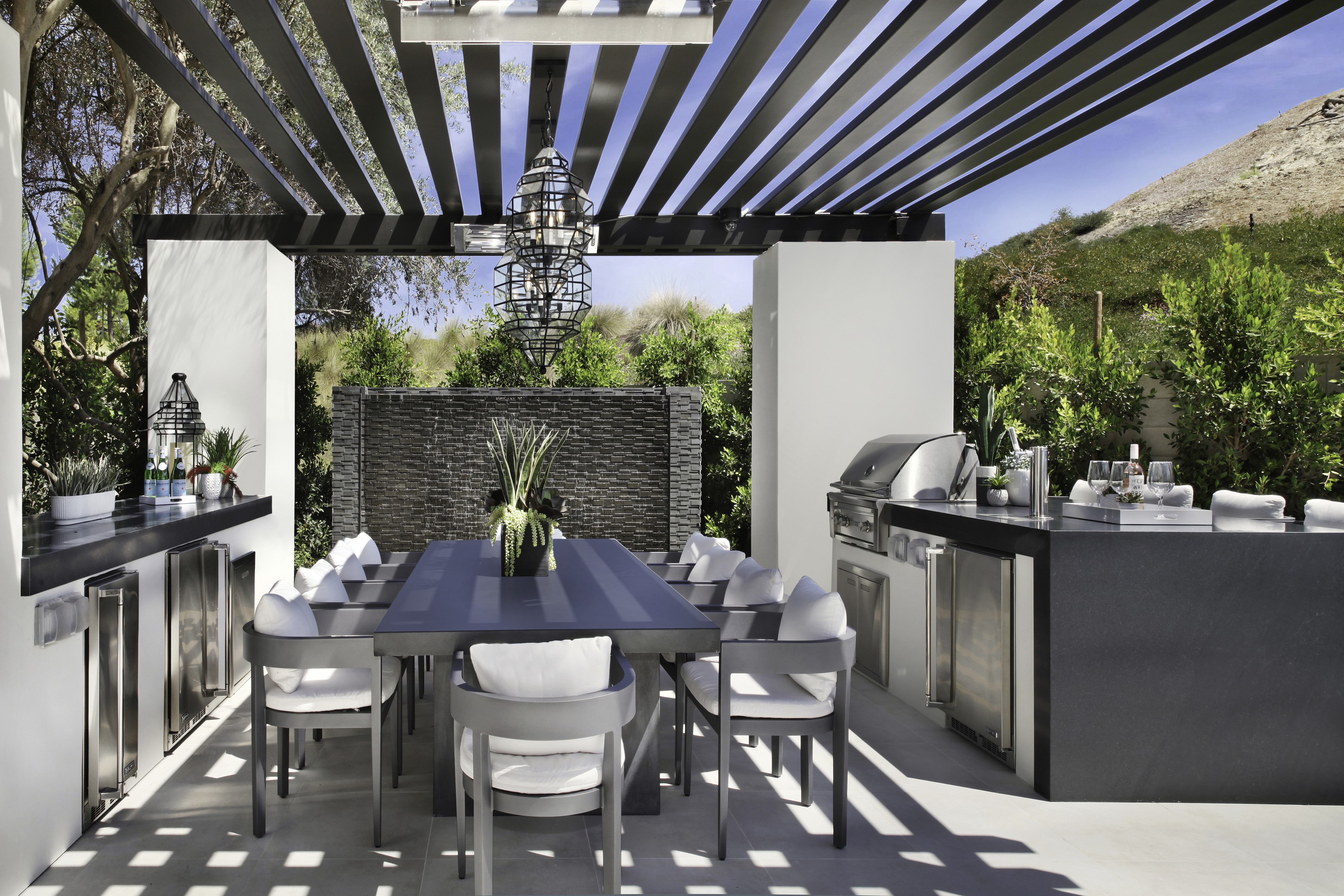 Outdoor kitchen with dining table and grill HD Wallpaper