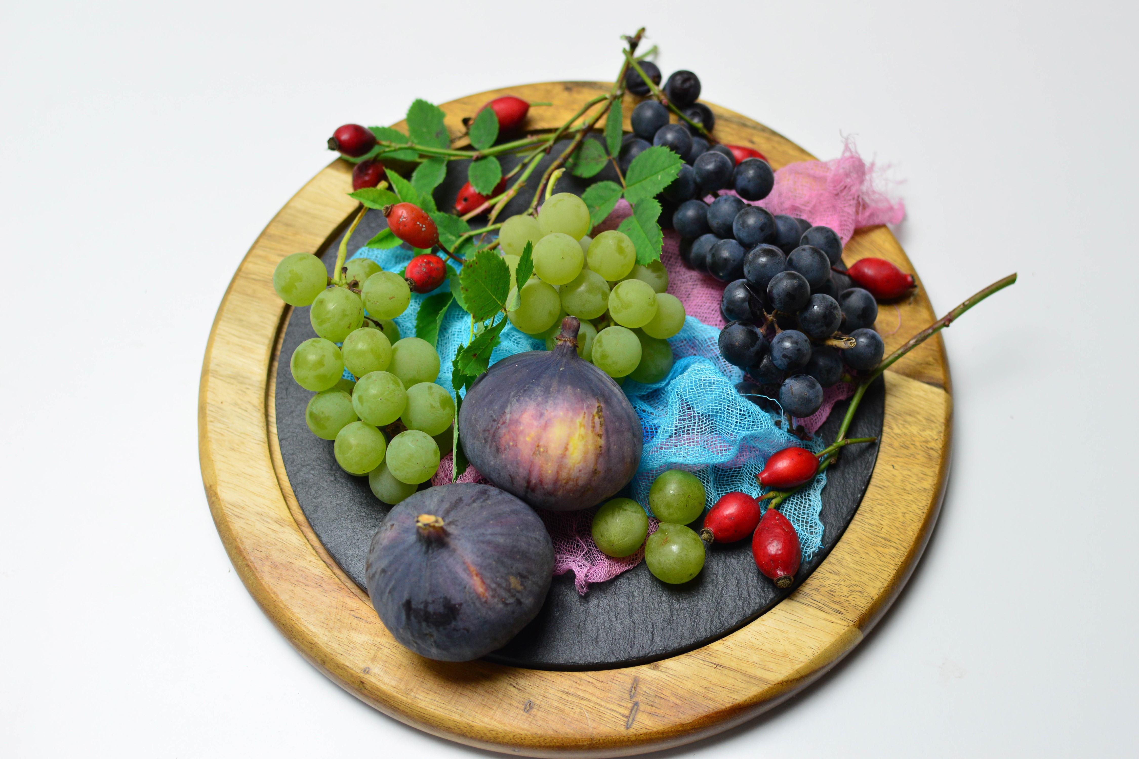 Grapes, Figs, and Rose Hips on a Cutting Board HD Wallpaper