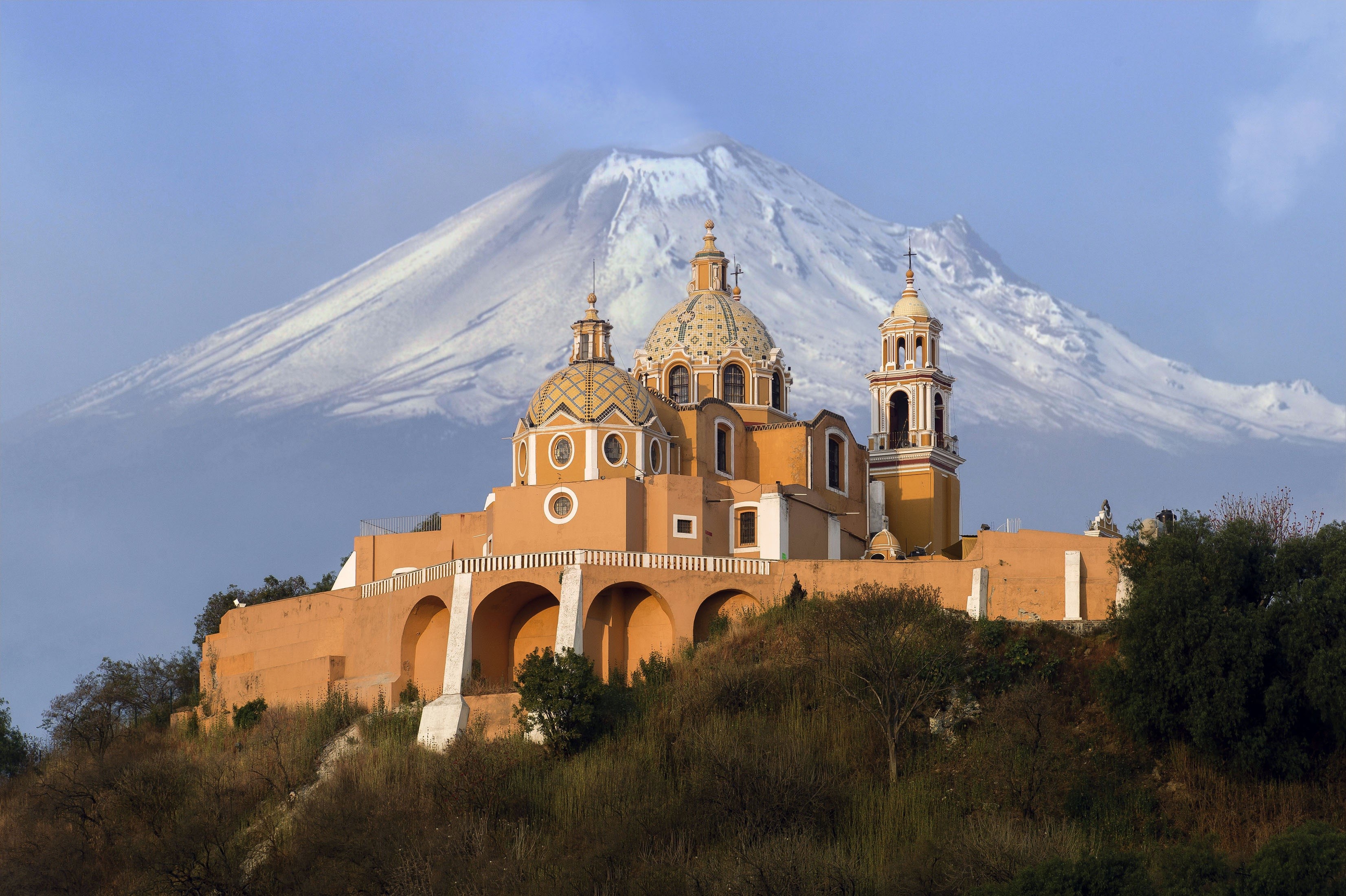 Church on a hill with a volcano in the background HD Wallpaper
