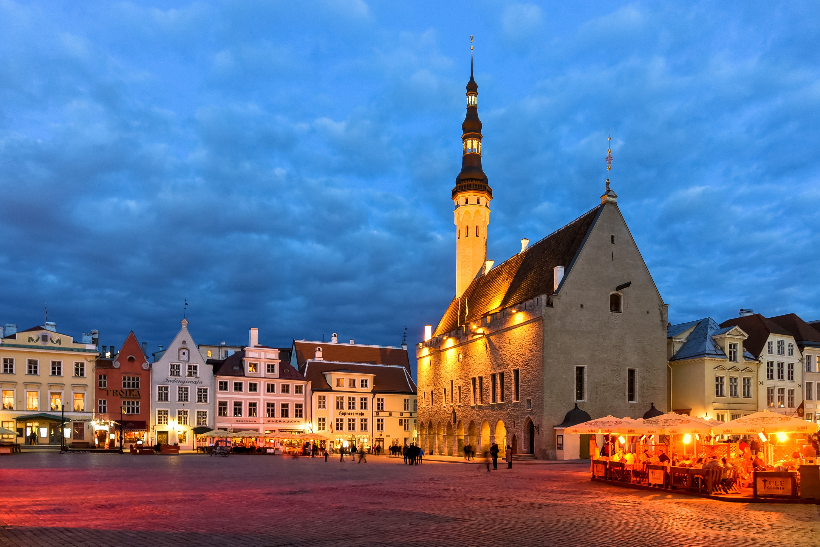 Tallinn Town Hall Square at dusk with outdoor cafes HD Wallpaper