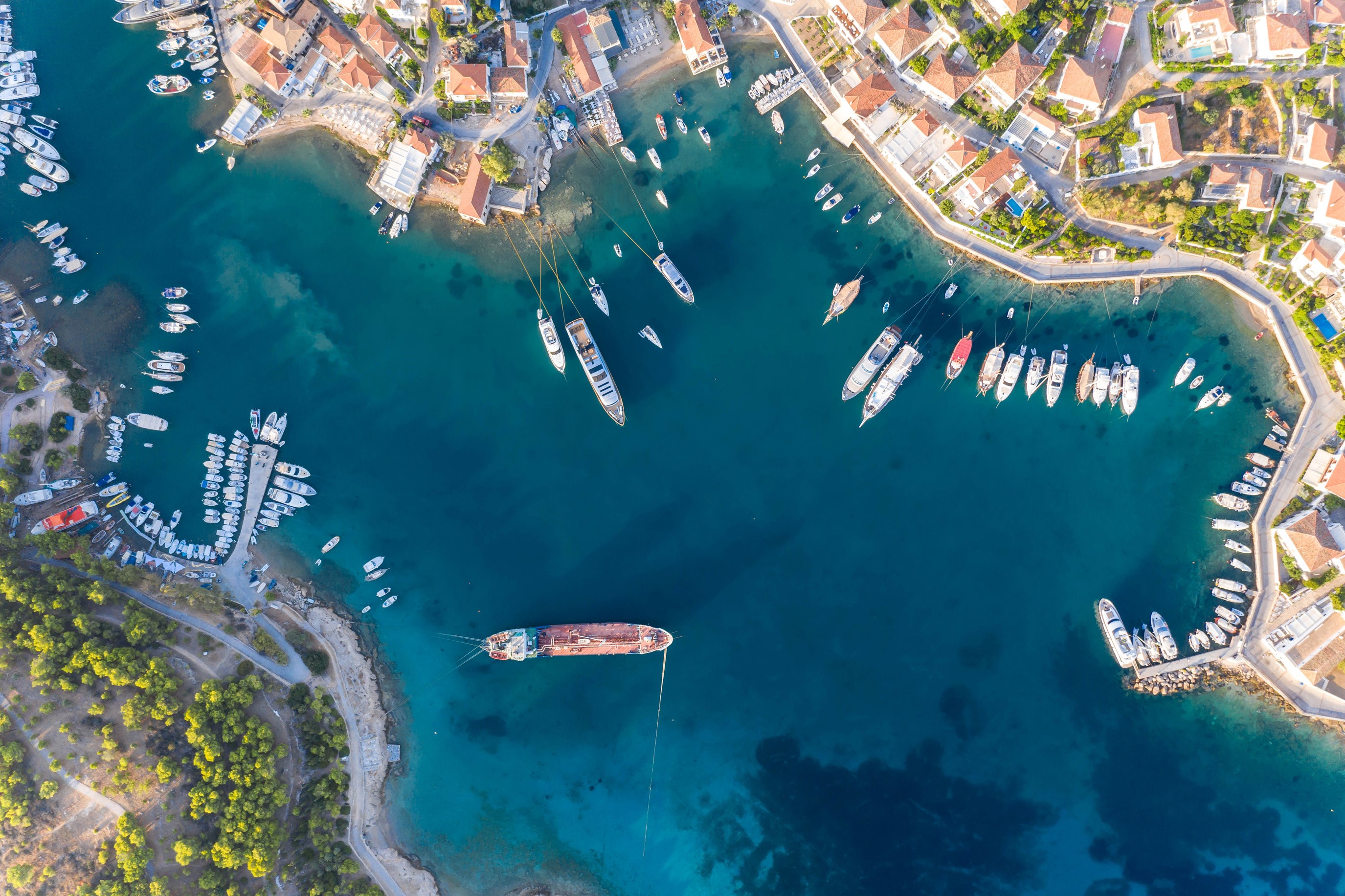 Aerial view of Spetses, Greece harbor with boats and houses HD Wallpaper