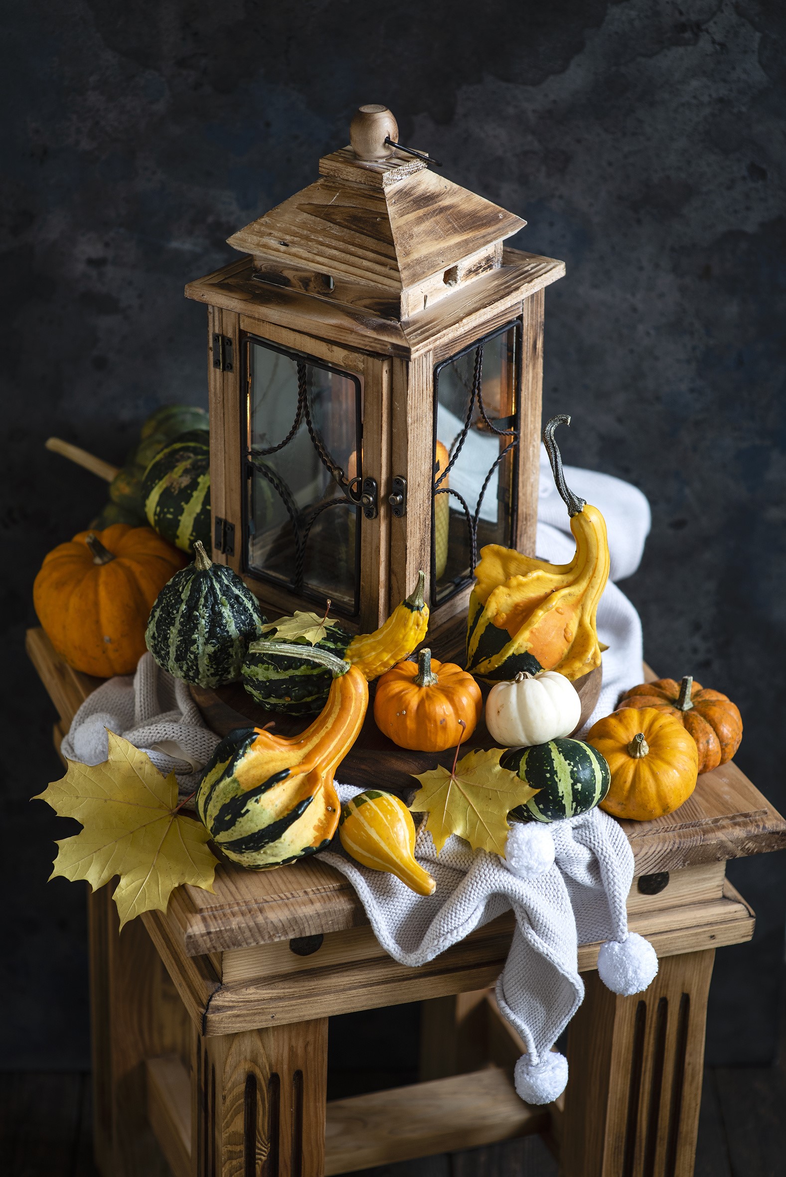 Autumn harvest display with wooden lantern and pumpkins HD Phone Wallpaper