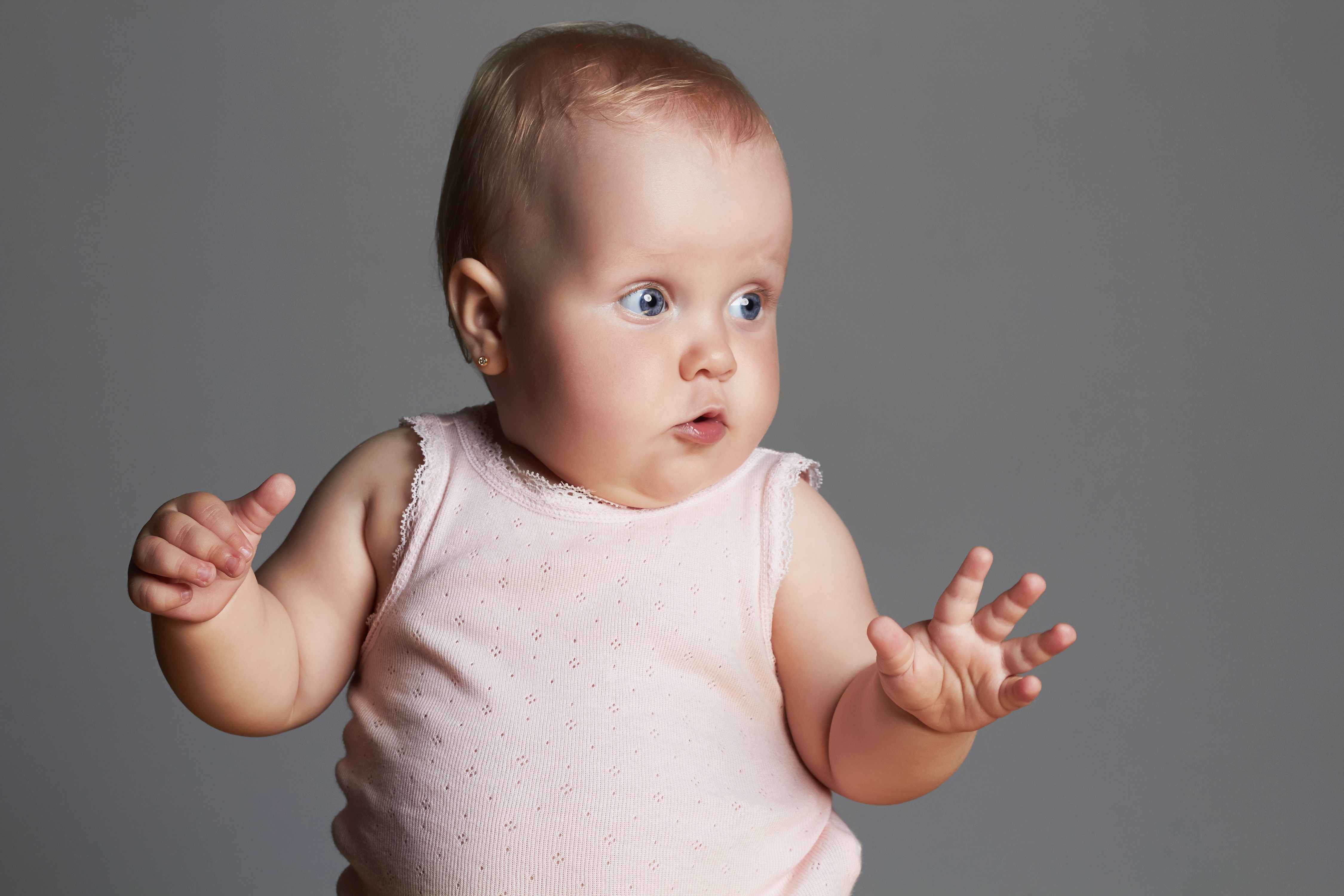 Infant with hands up on gray background HD Wallpaper