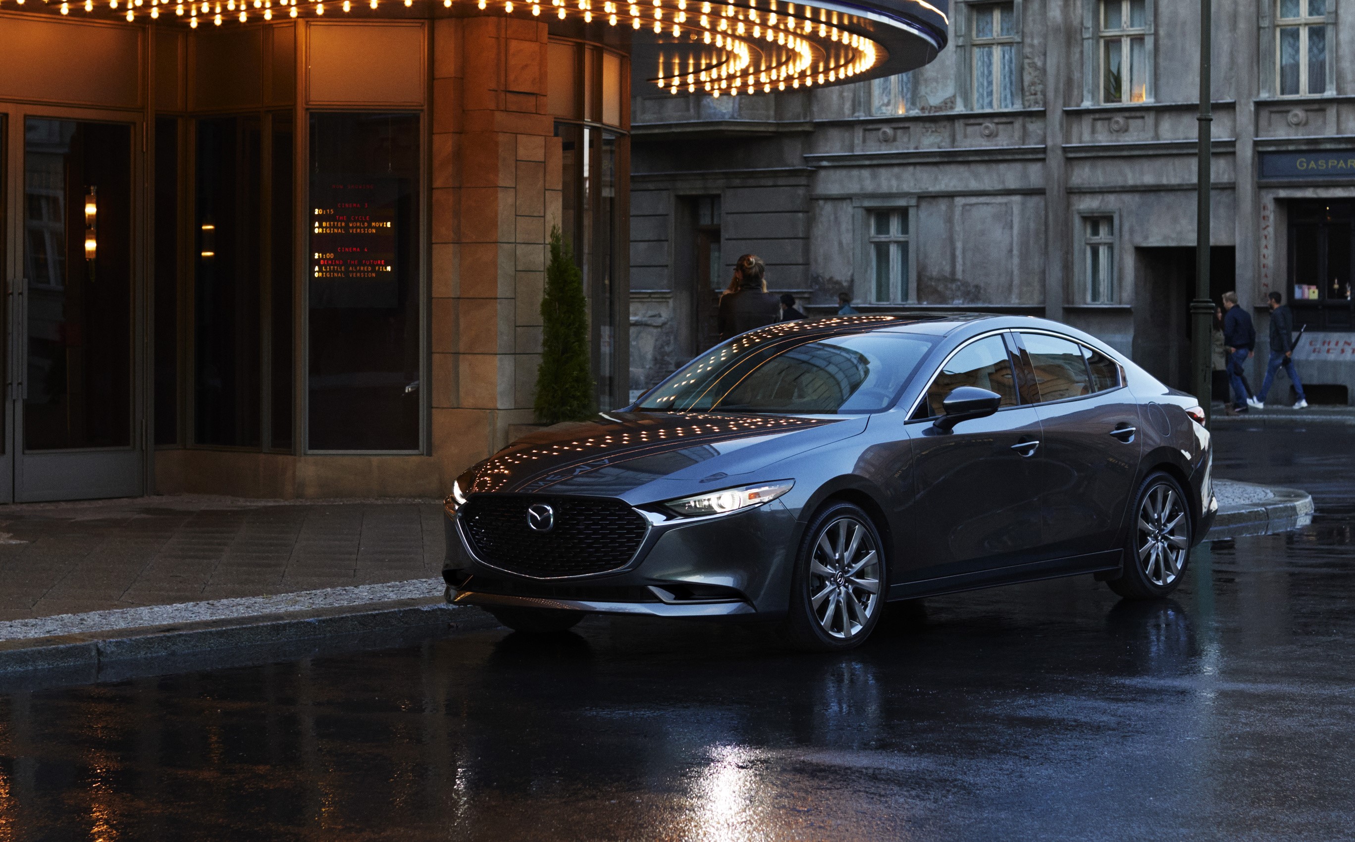 2020 Mazda3 Sedan parked outside a theater HD Wallpaper