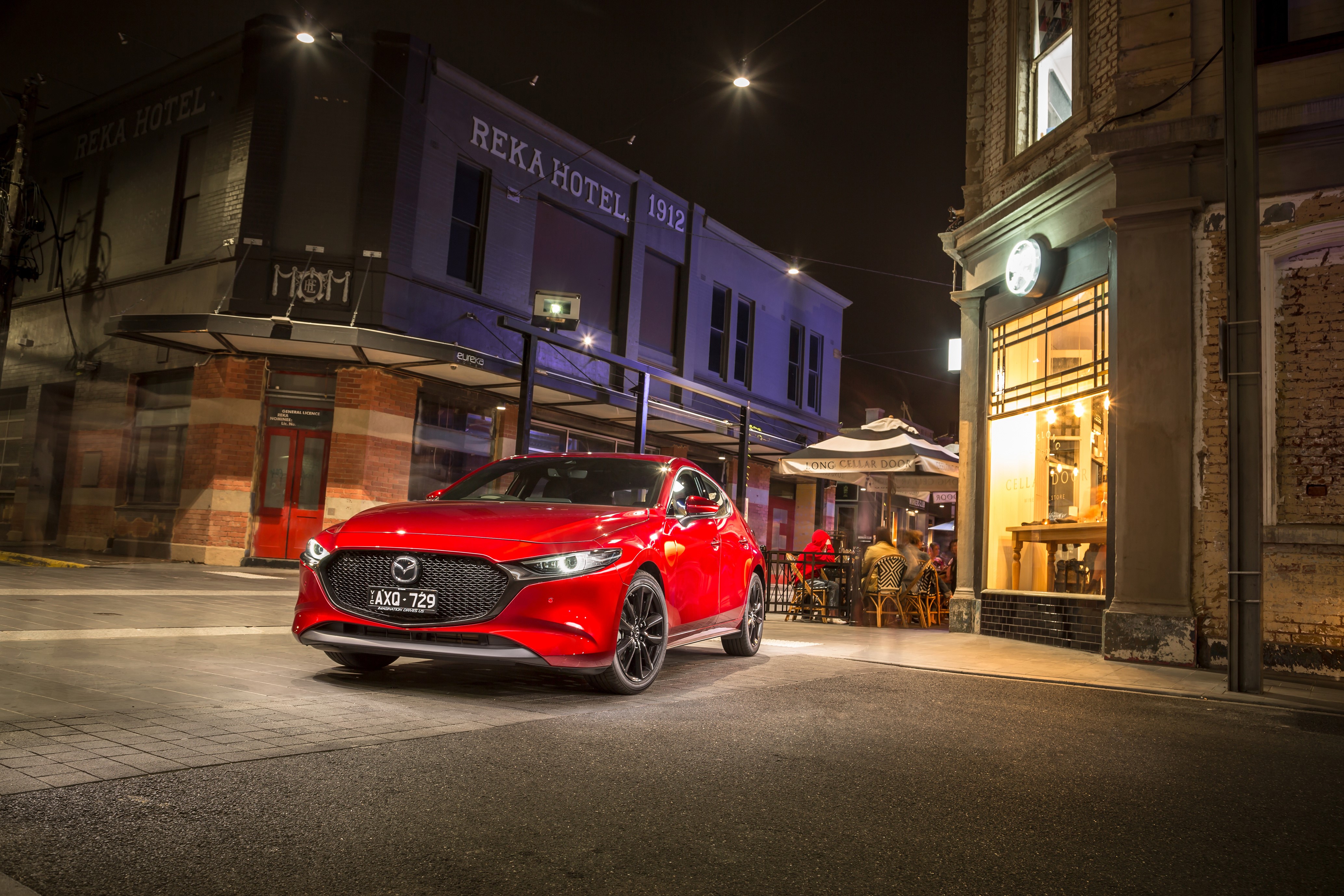 Red 2019 Mazda3 Skyactiv-G Hatchback at night HD Wallpaper
