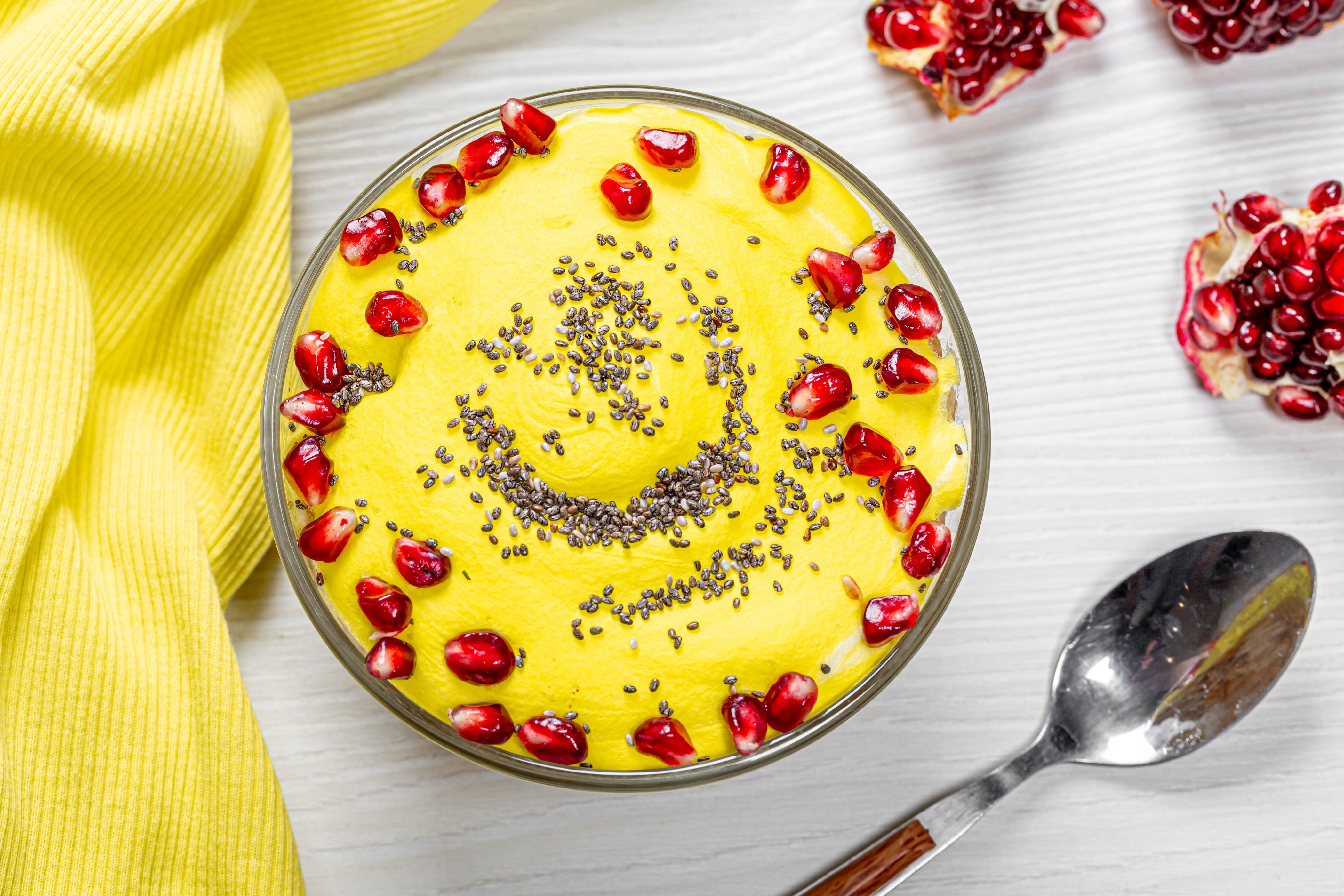 Yellow smoothie bowl with pomegranate and chia seeds HD Wallpaper