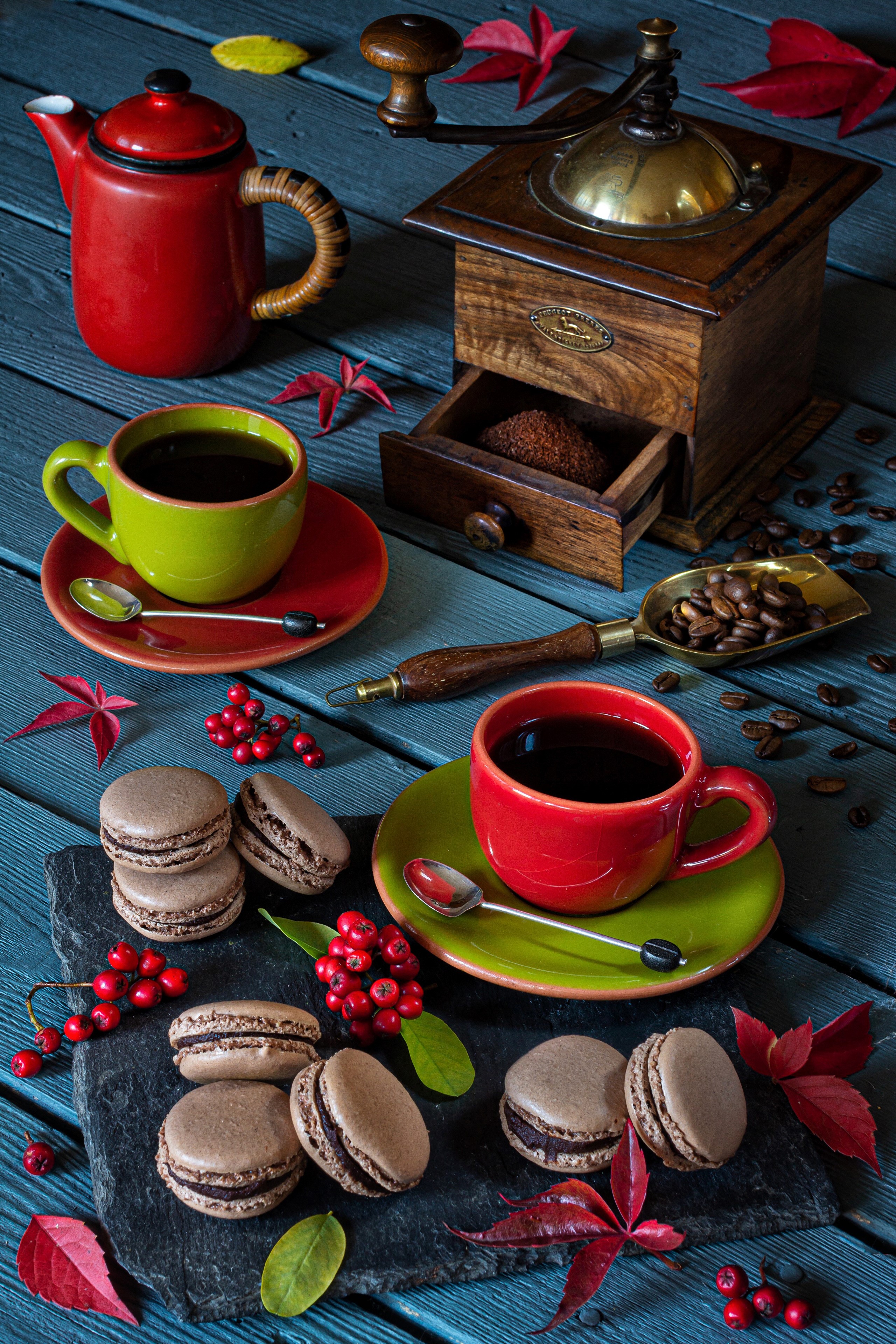 Coffee cups, macarons, and coffee grinder on wooden table HD Phone Wallpaper
