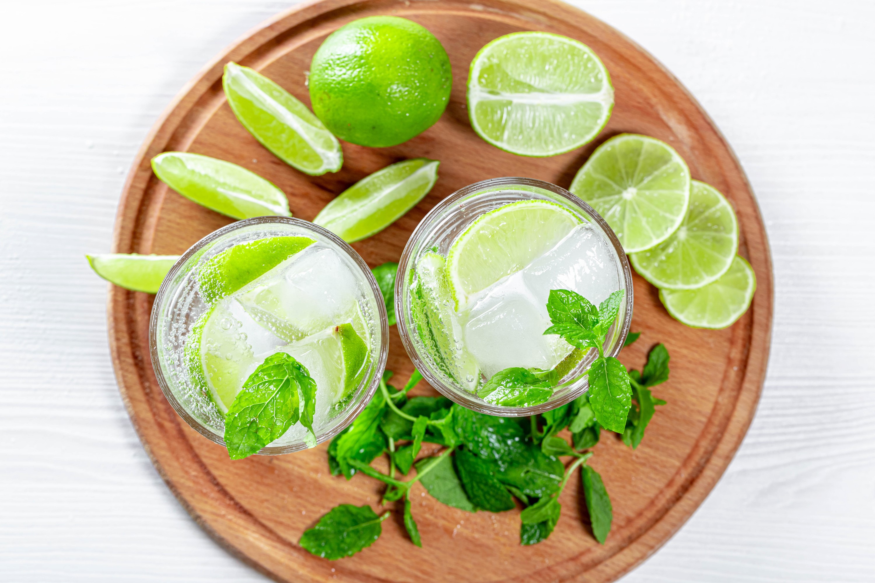 Two Mojitos with Lime and Mint on a Cutting Board HD Wallpaper