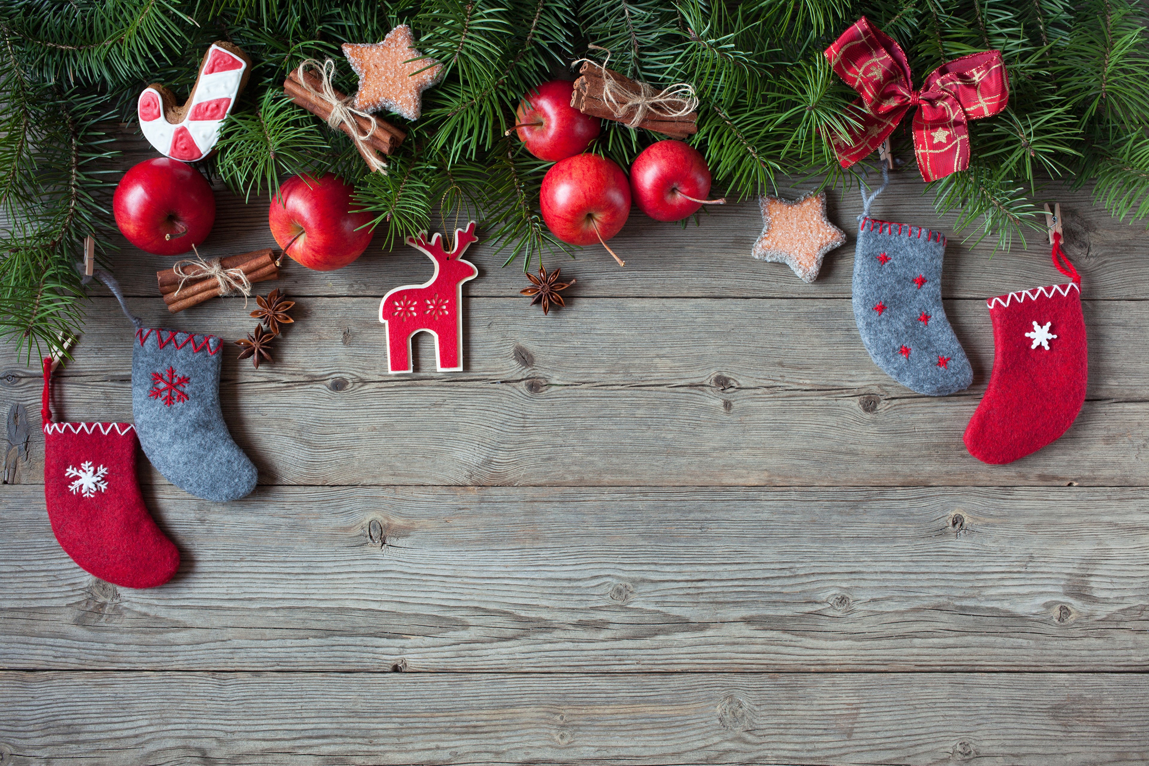 Christmas decorations with apples and pine branches on wood HD Wallpaper