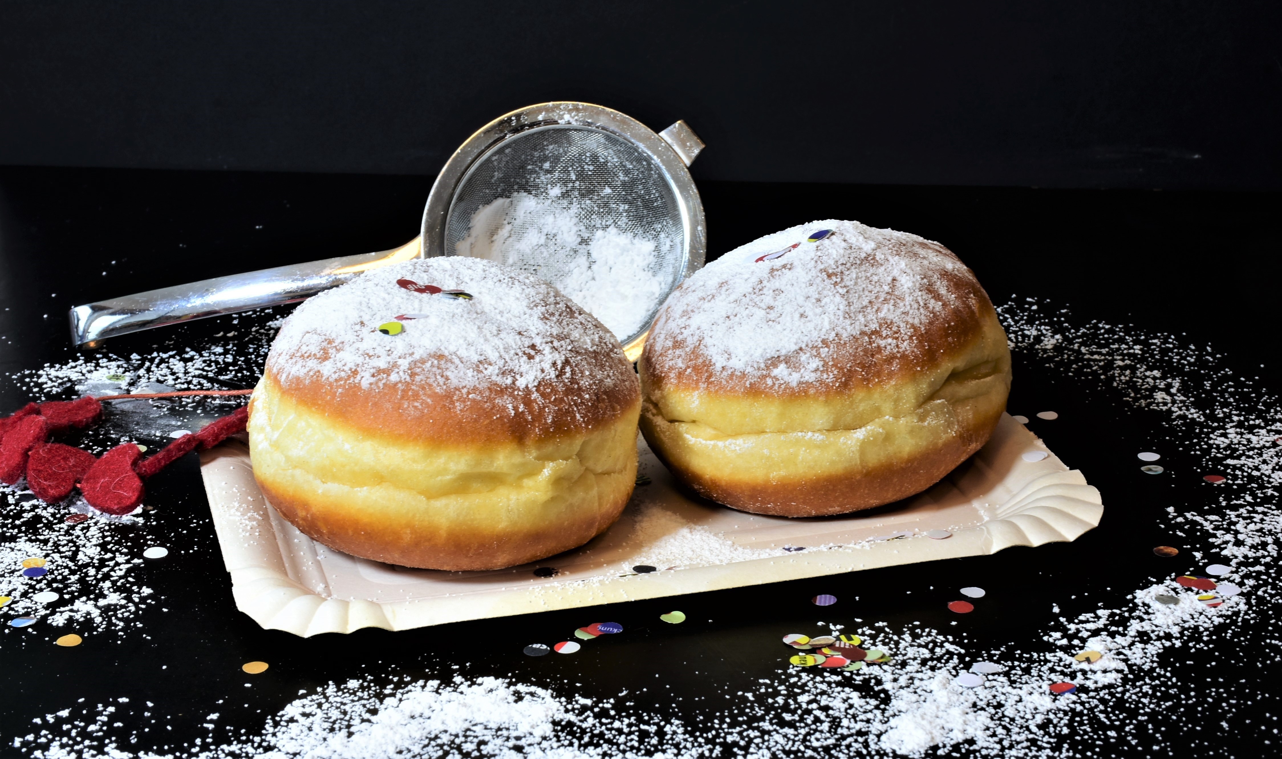 Two donuts with powdered sugar and confetti HD Wallpaper