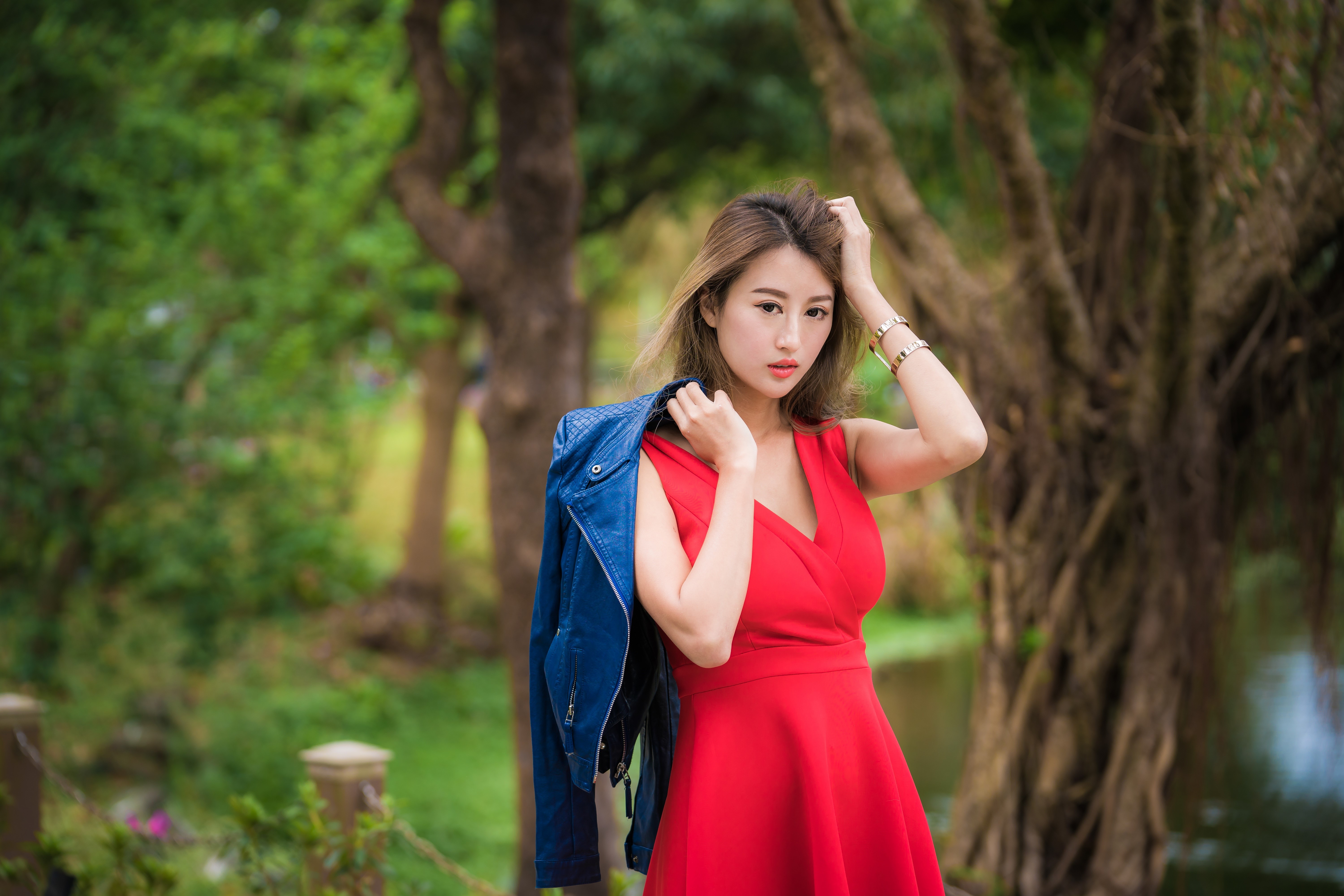 Asian woman in red dress holding blue jacket HD Wallpaper