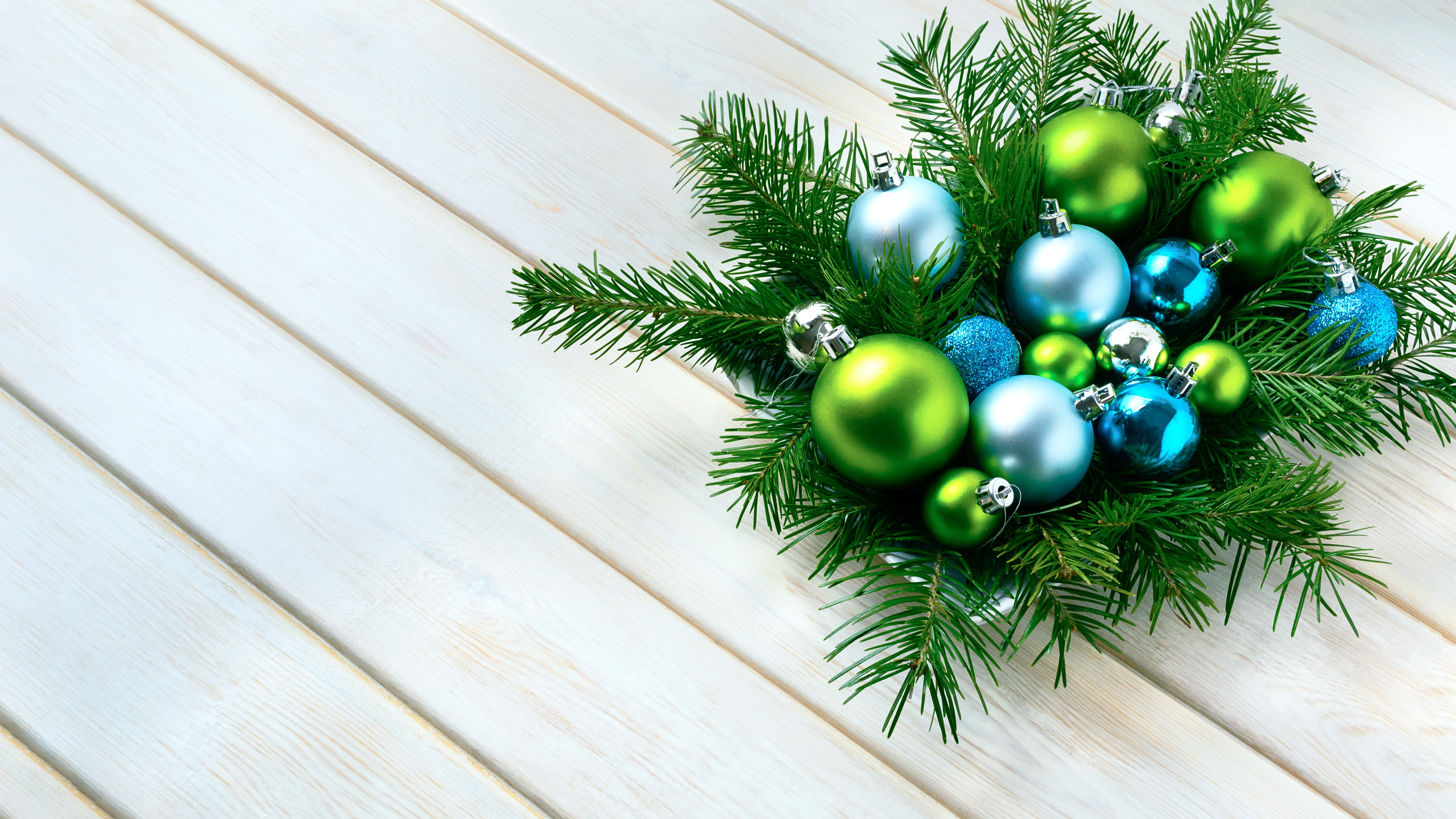 Christmas branches with green and blue ornaments on wood planks HD Wallpaper
