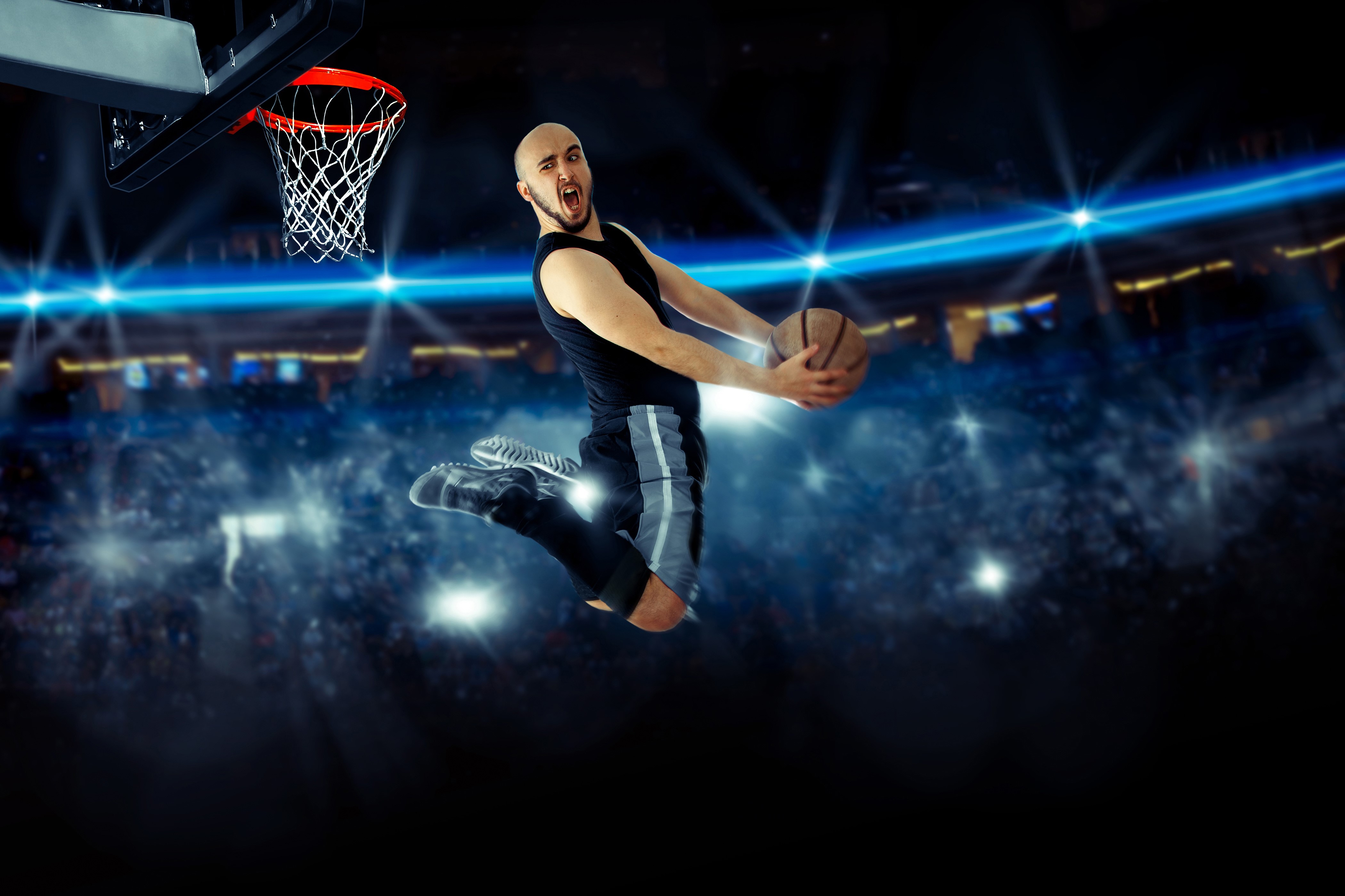 Man jumping with basketball in arena HD Wallpaper