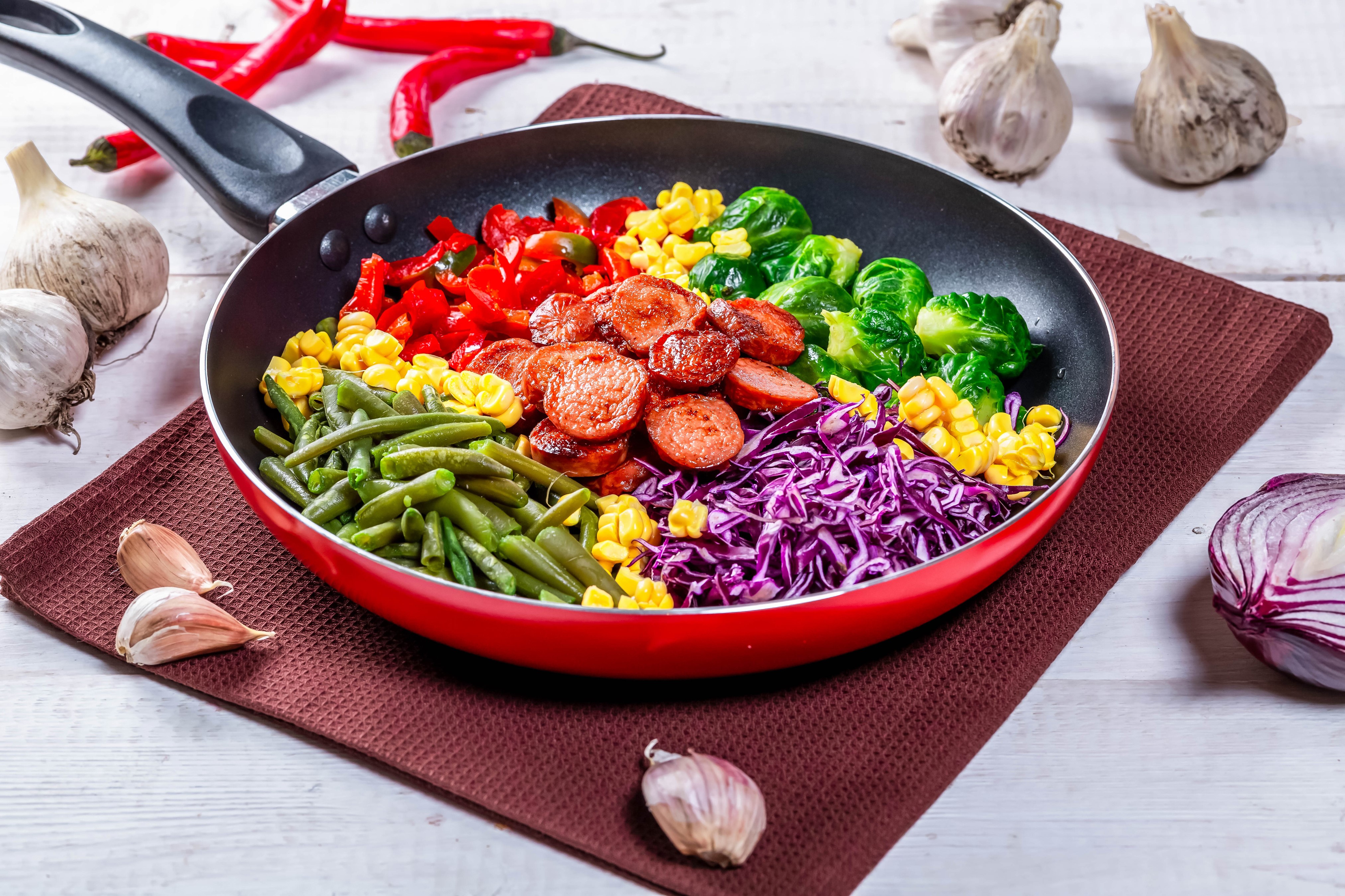 Frying pan with sausages and vegetables HD Wallpaper