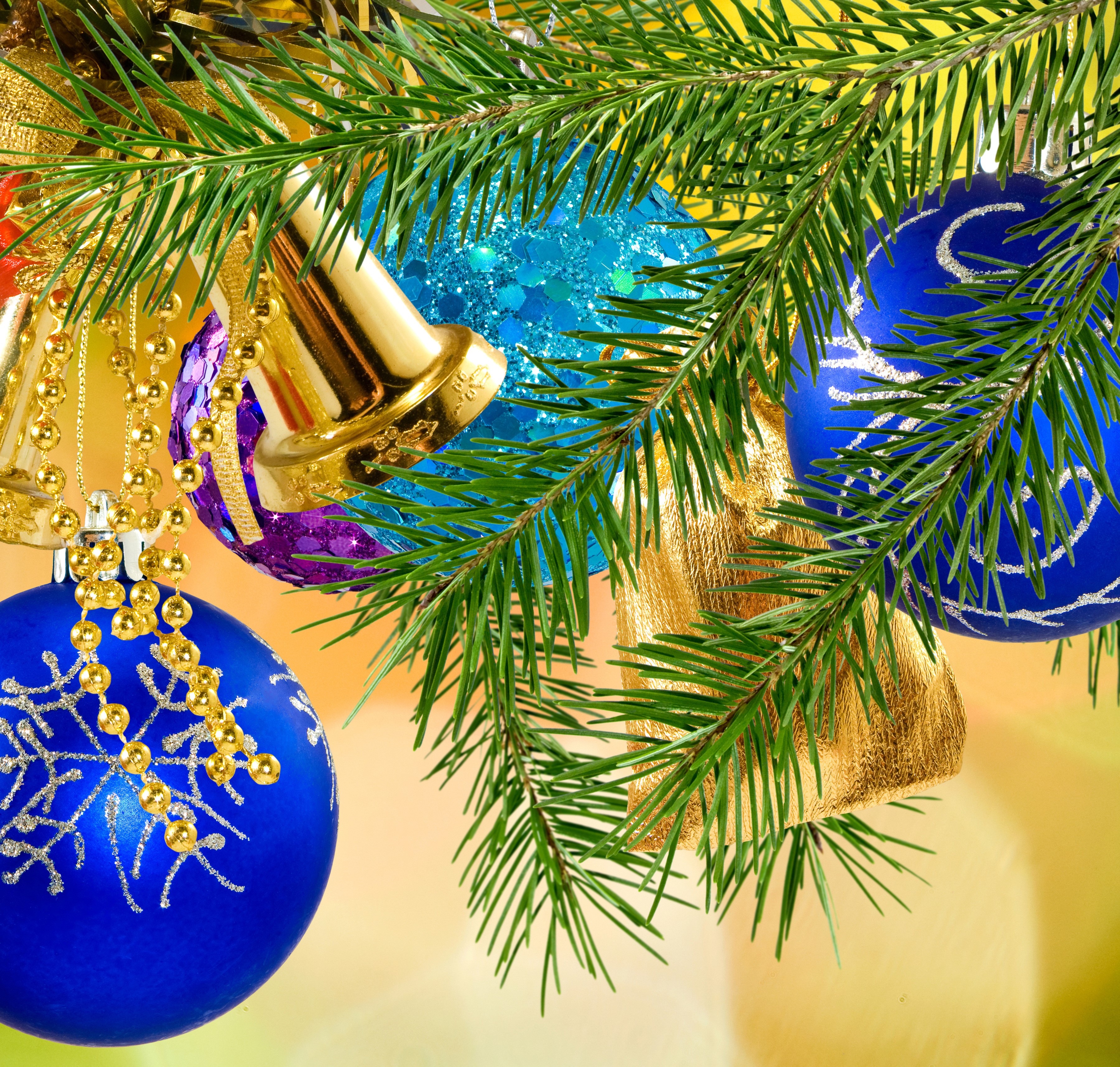 Christmas tree branches with blue and gold ornaments HD Wallpaper