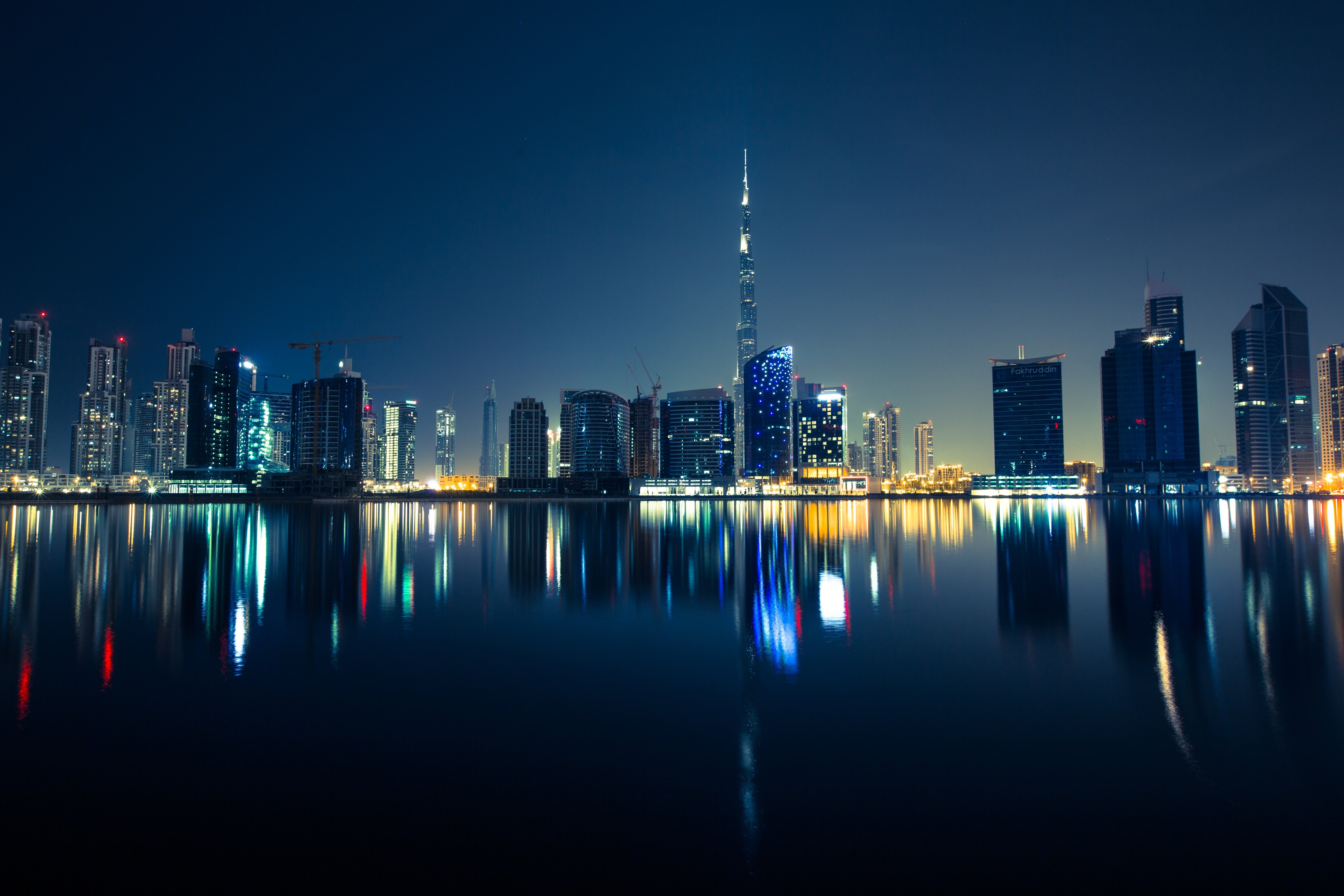 Dubai skyscrapers at night with water reflection HD Wallpaper