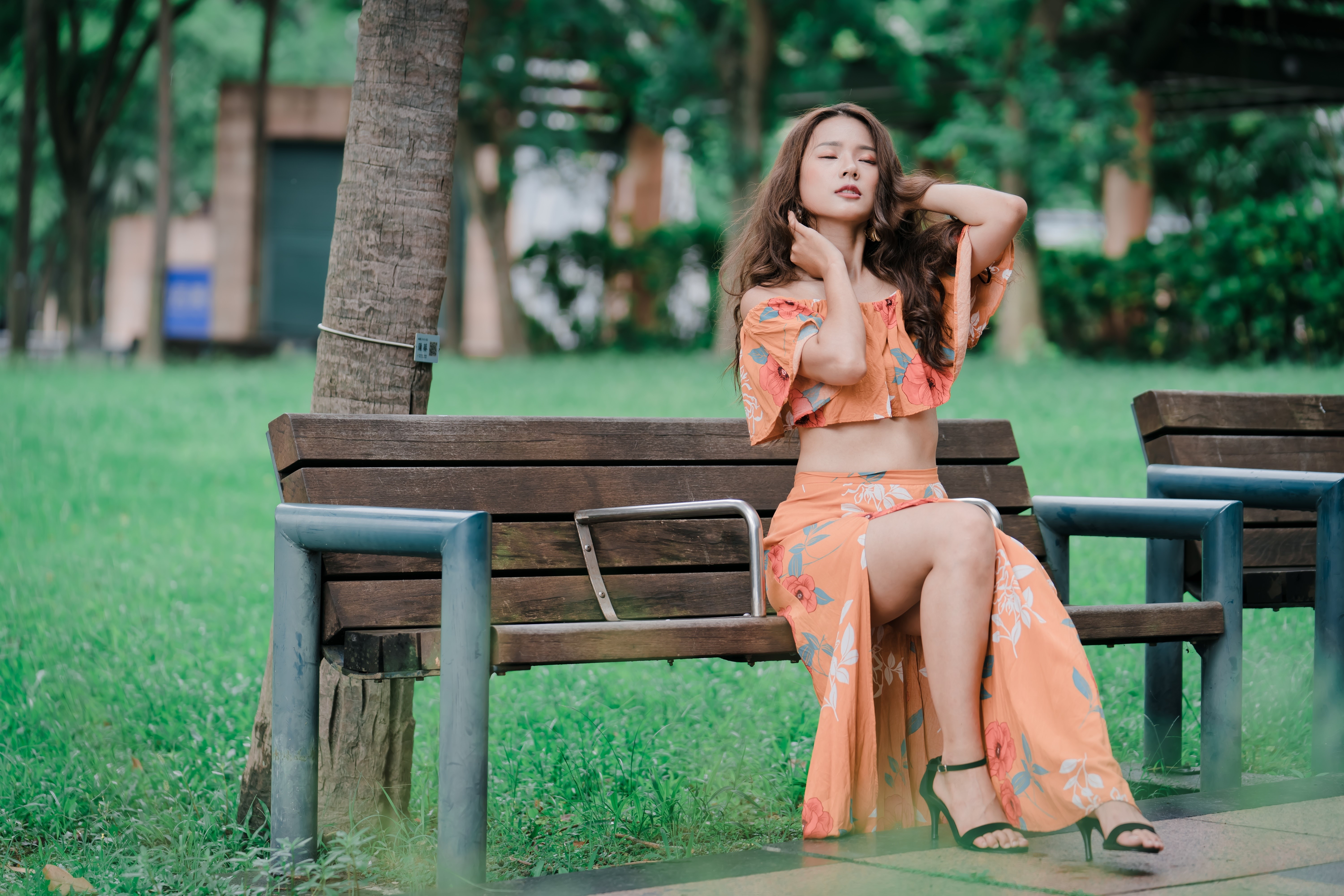 4K Elegant Woman Sitting on a Park Bench HD Wallpaper