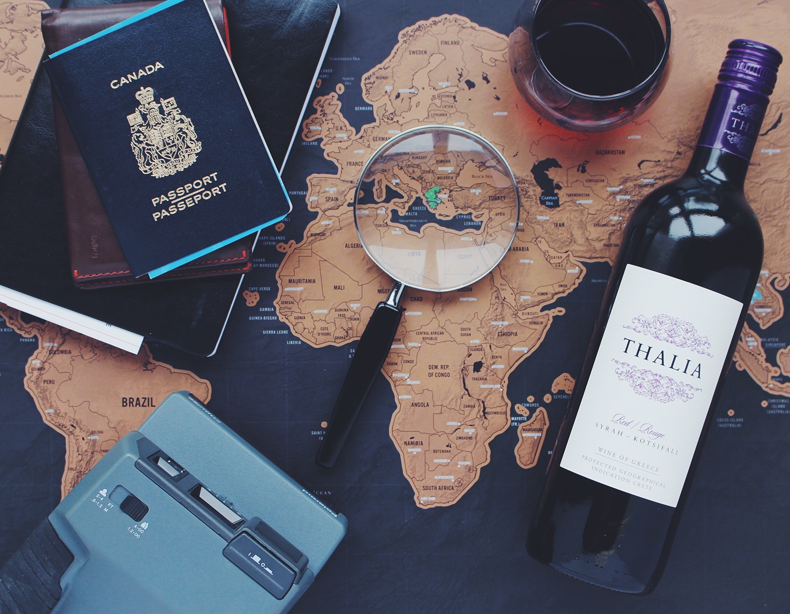 Travel items on a world map HD Wallpaper