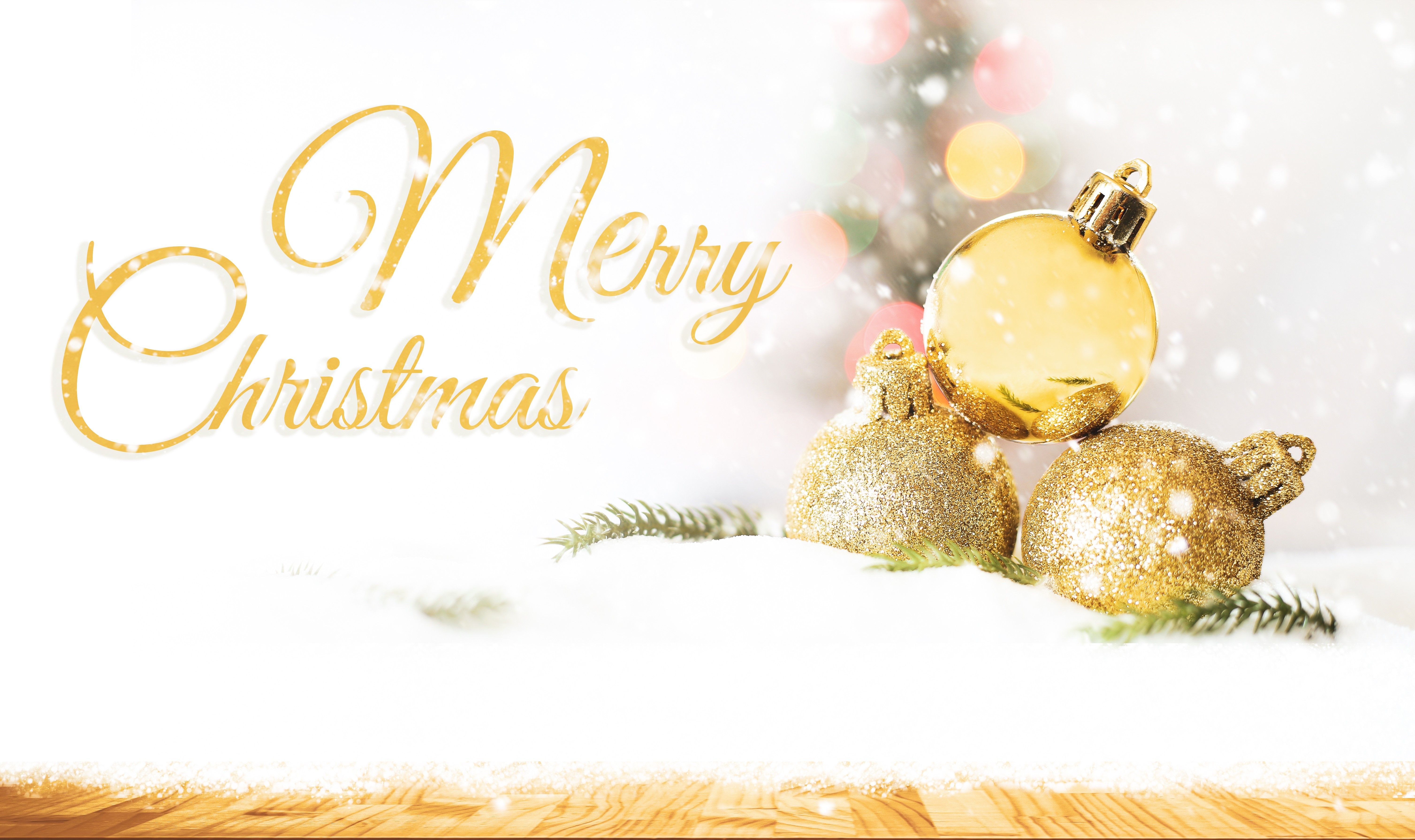 Merry Christmas text with golden ornaments in snow HD Wallpaper