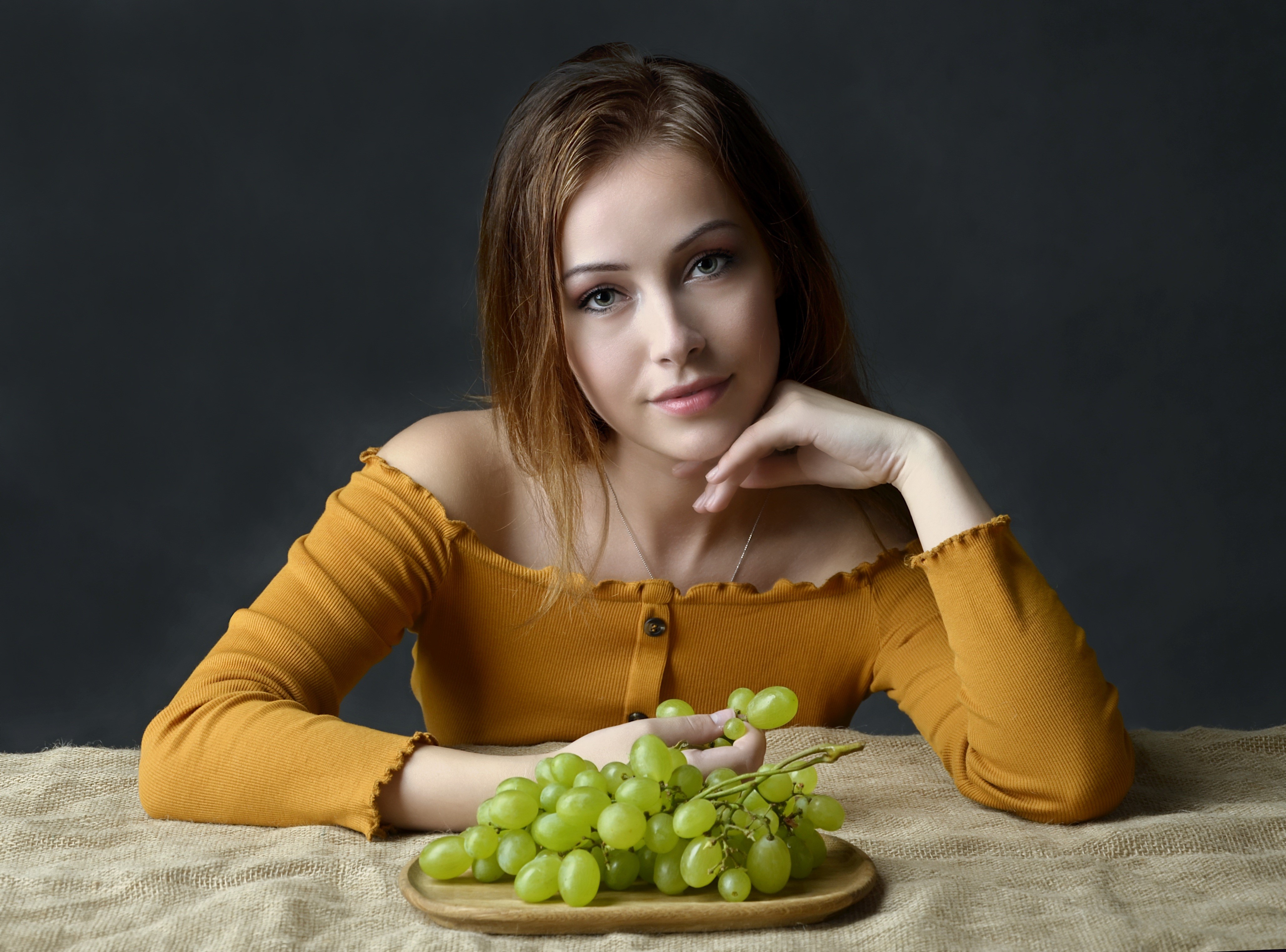 Young Woman with Green Grapes in 4K HD Wallpaper